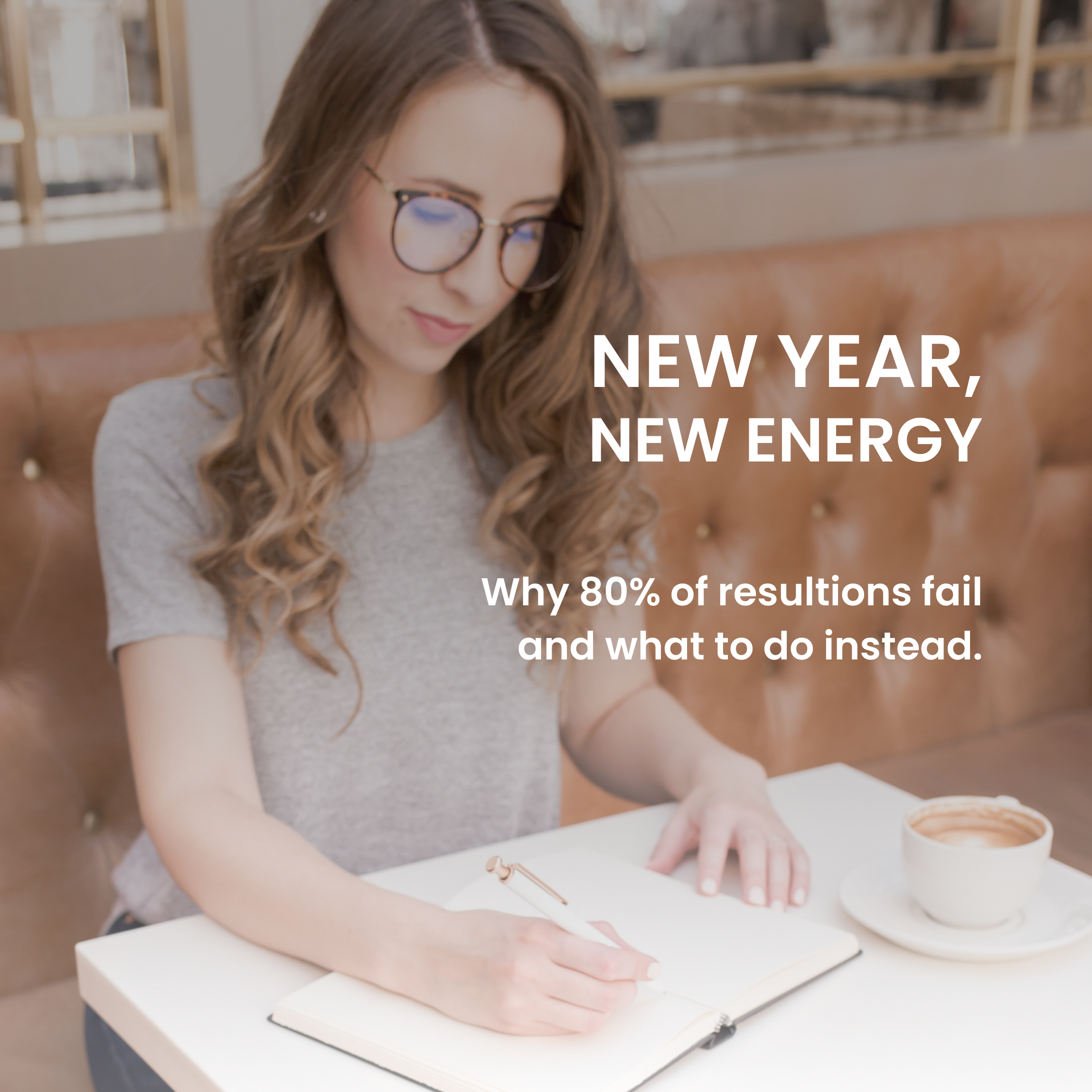 Woman with brown hair and glasses writing 2026 intentions in a journal with coffee on the side