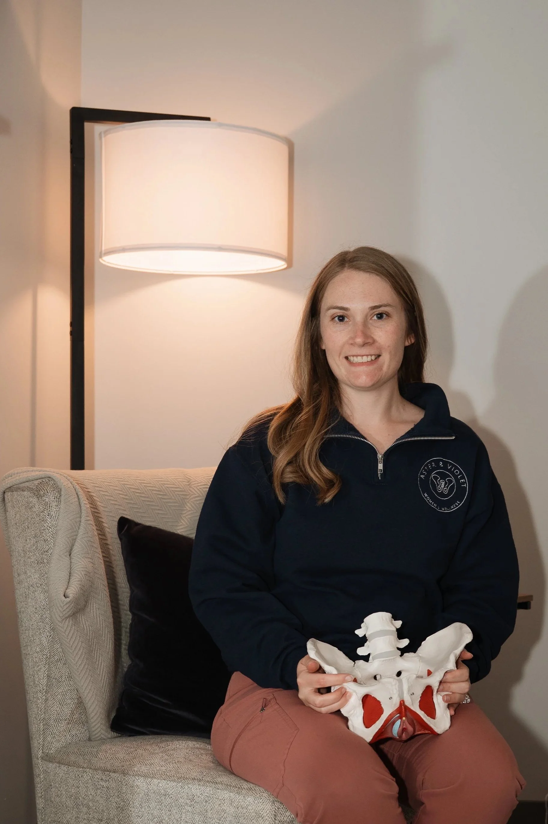 Dr. Taylor, columbiana’s best pelvic floor physical therapist, hold a pelvic model