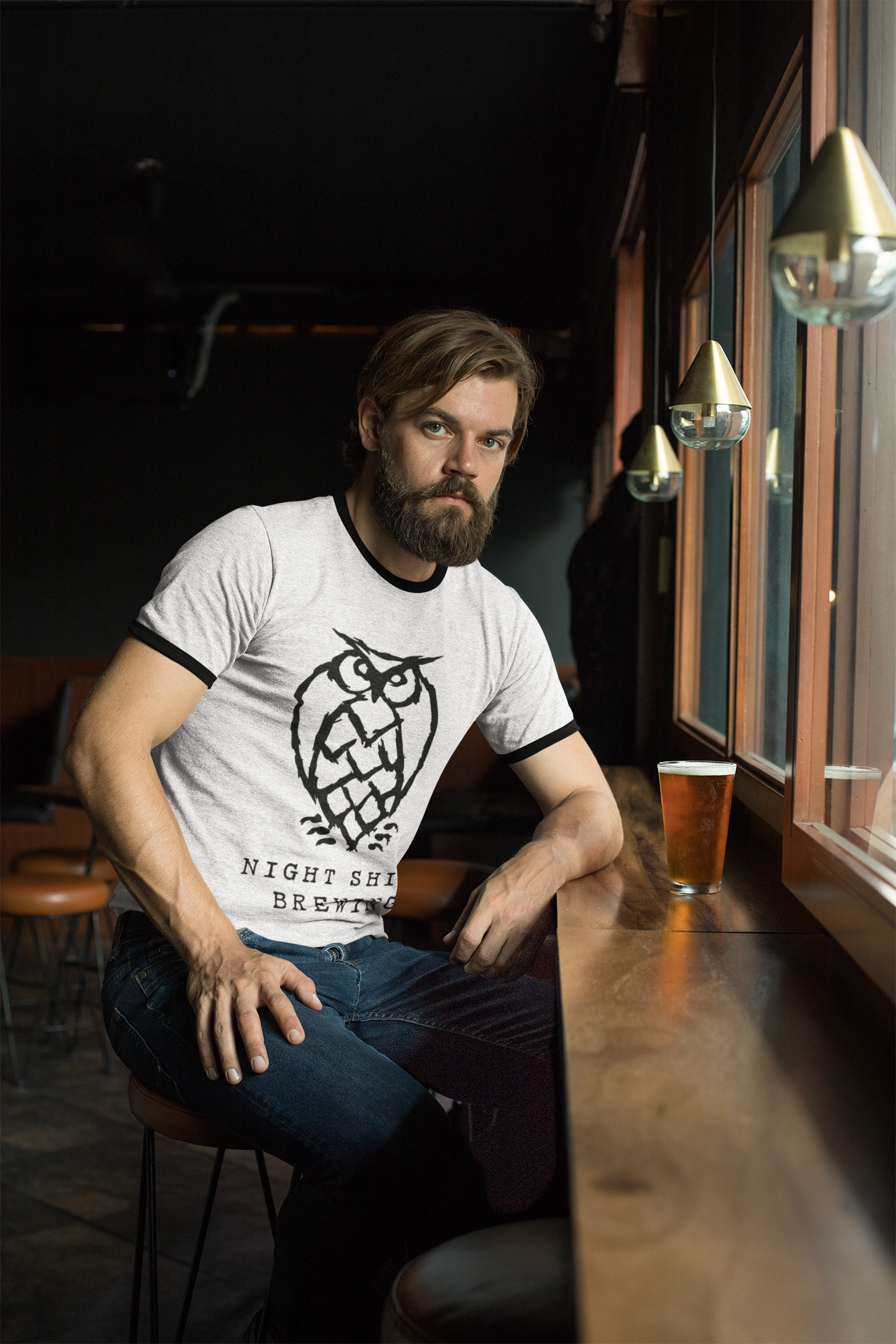 heather-ringer-tee-mockup-of-a-man-drinking-a-beer-in-a-bar-27930.png