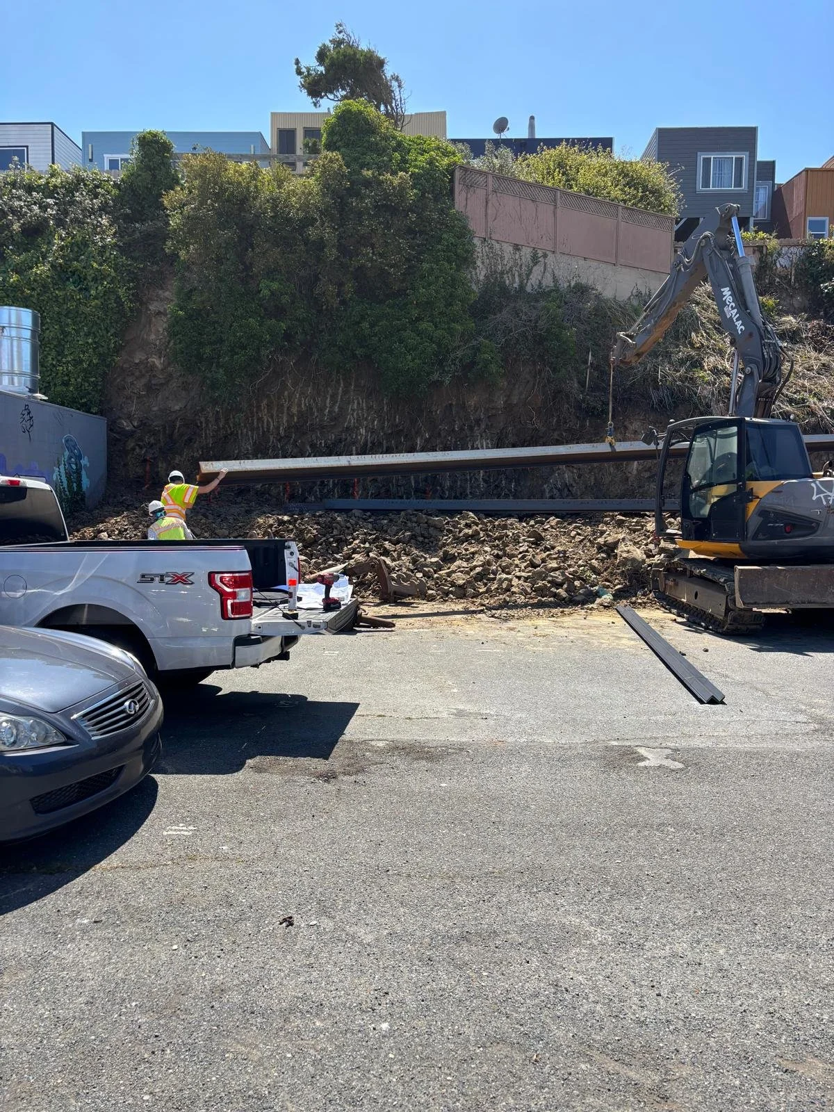 Steel beams delivered to site for use in retaining wall construction.