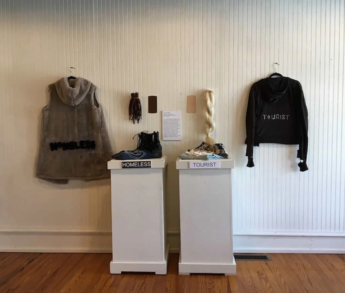 HOMELESS | TOURIST, 2017. Natural and synthetic hair, faux fur, bling stickers, clothing, shoes, Behr paint samples. Size varies.