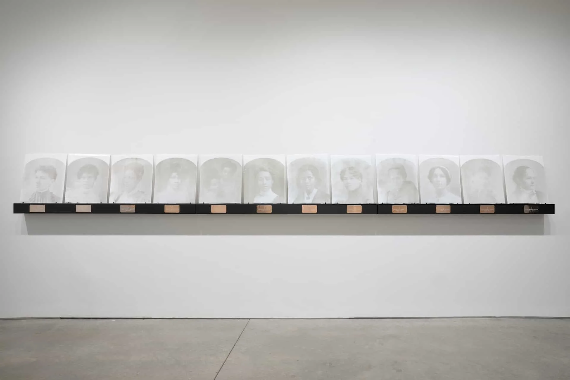 BLACKTIVISTS, 2024. Hand-screenprinted portraits on opaque white opalescent Bullseye glass, deep gray frit, kiln fired. 17 x 20” each (set of 12).