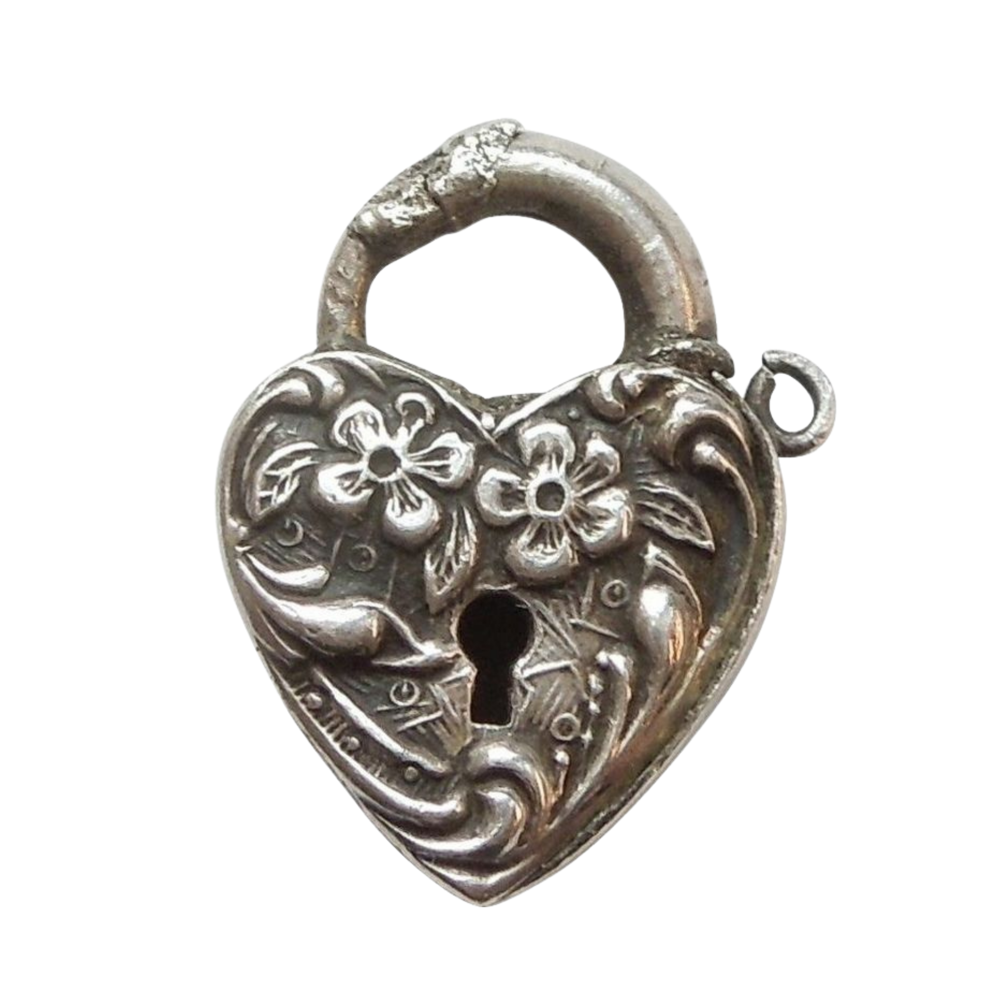 Close-up of an ornate silver or metallic decorative object with intricate floral and swirl design.