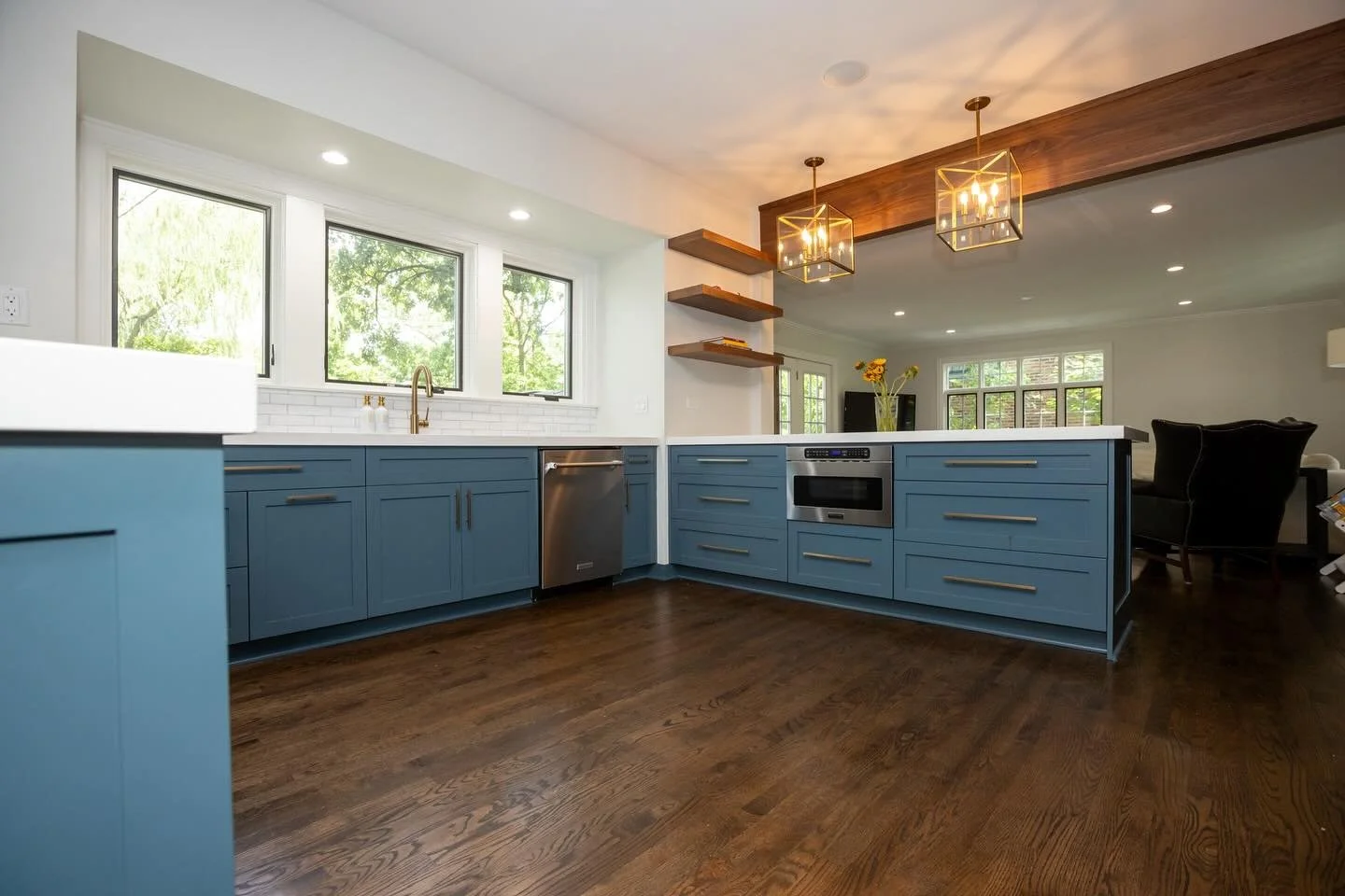 After opening up closed off adjacent spaces, the dining and living rooms now relate and flow back to this remodeled Beverly kitchen.