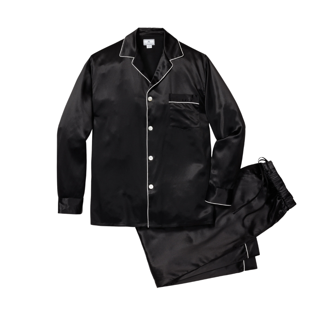 Black satin pajama set with white piping, including long-sleeve button-up top and matching pants.