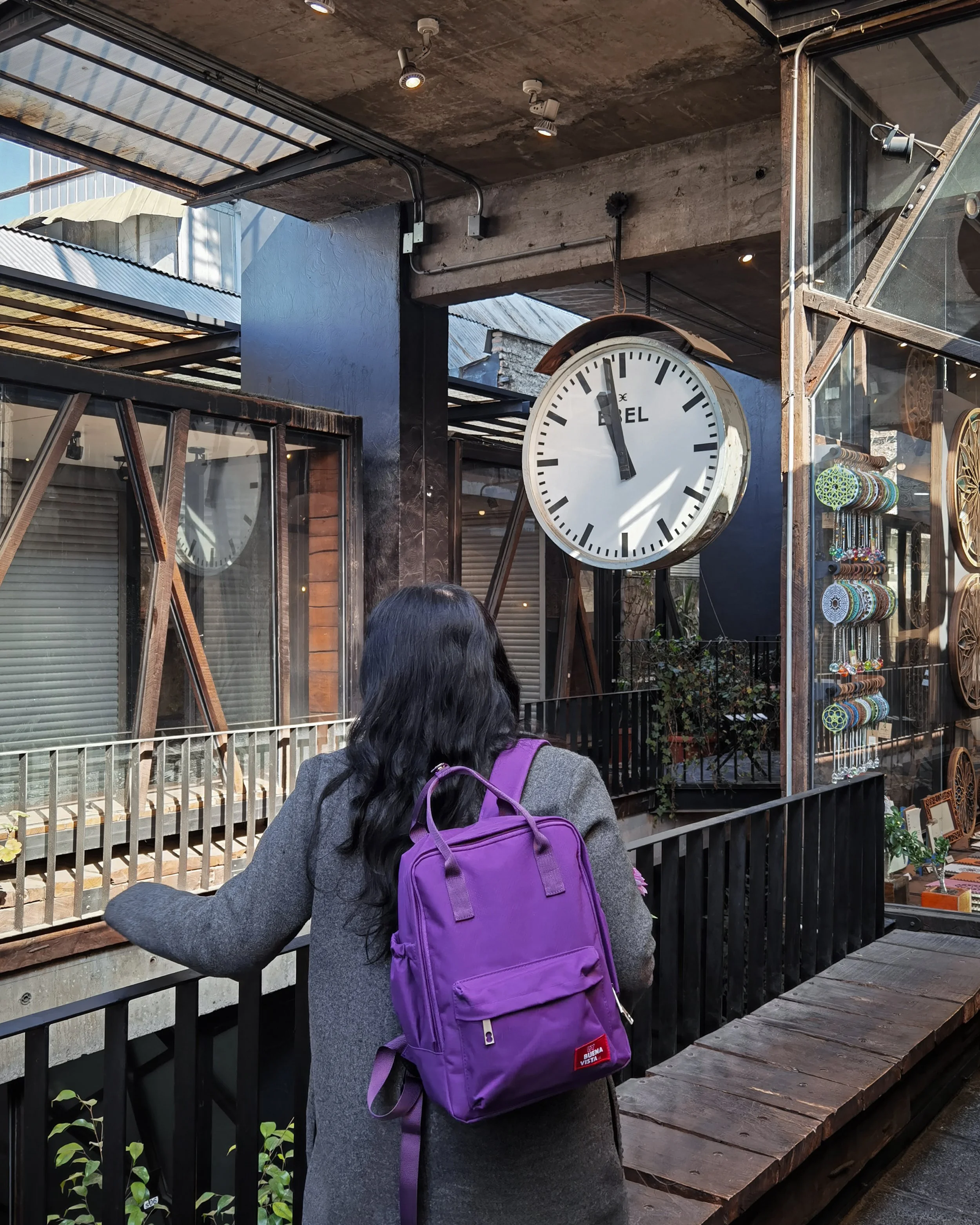 Traveller beside a street clock in central Santiago, Chile
