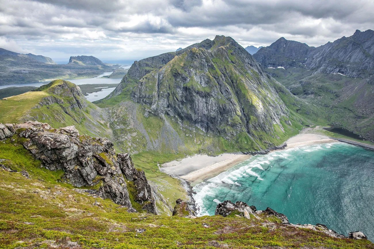 Turquoise water and pale sand at Kvalvika Beach seen from the mountain trail in Lofoten