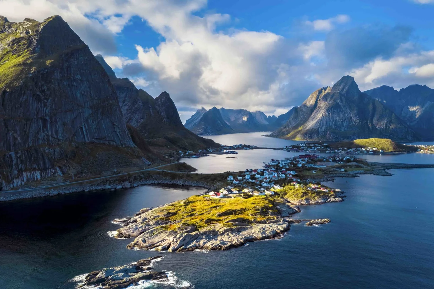The fishing village of Reine surrounded by peaks and fjords in the Lofoten Islands