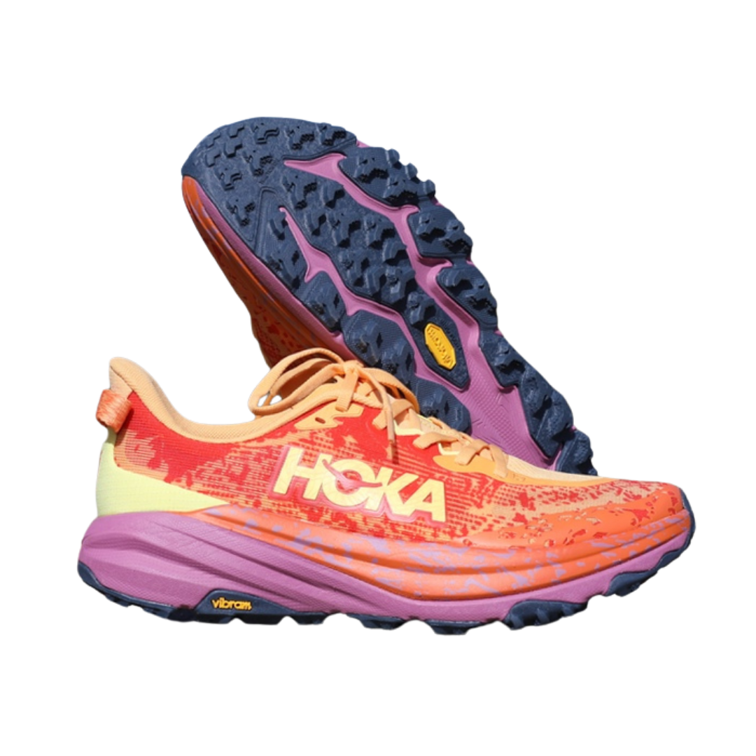 Colorful Hoka trail running shoes with orange, pink, purple, and yellow accents, one shoe upright and one shoe tilted to show the sole.