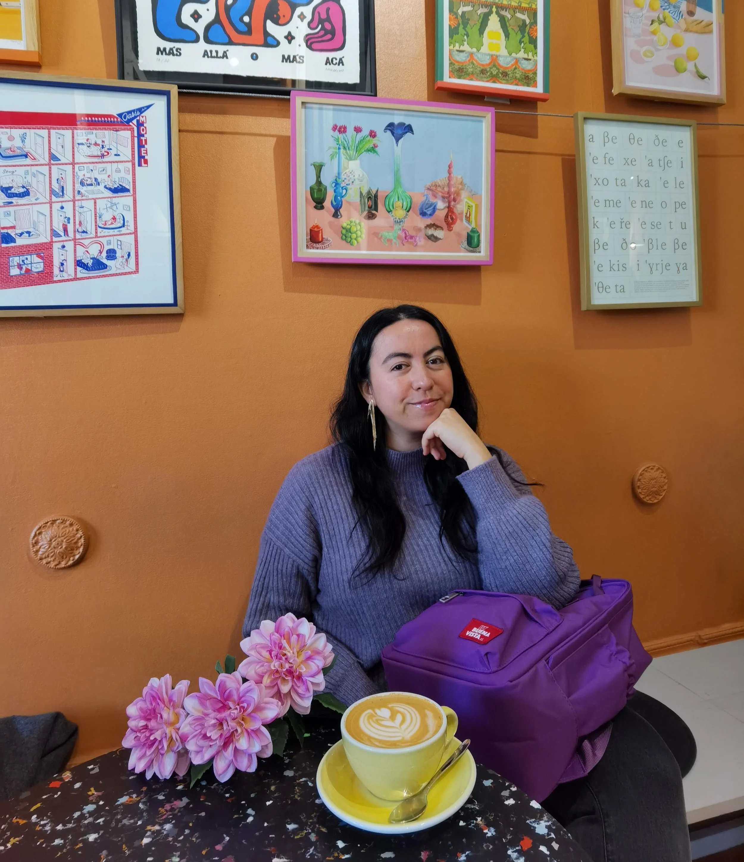 Cafe in Santiago, Chile, with latte art and framed artwork on the wall