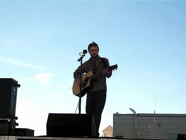 Man performing with guitar on stage