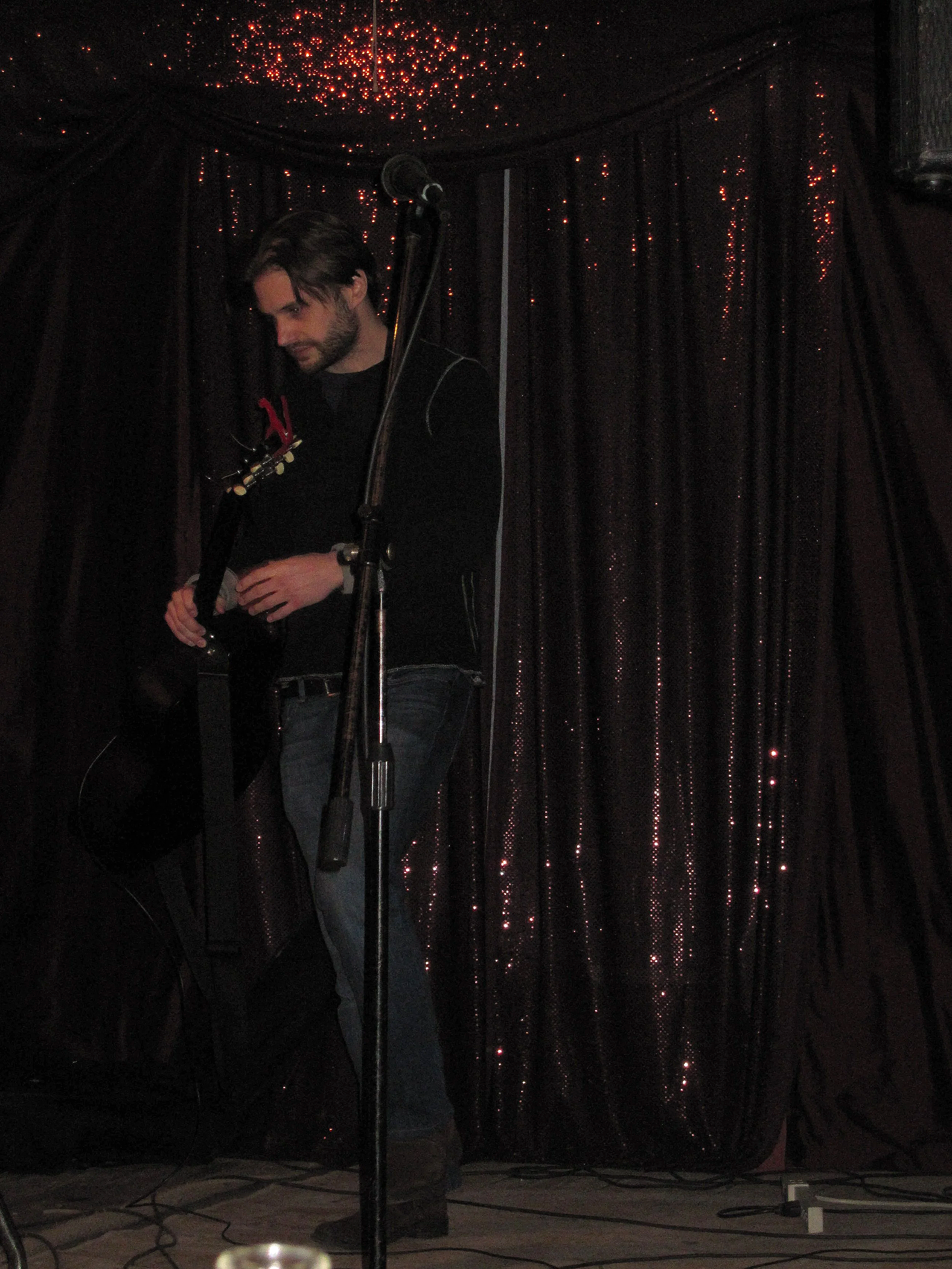 Man with guitar on stage