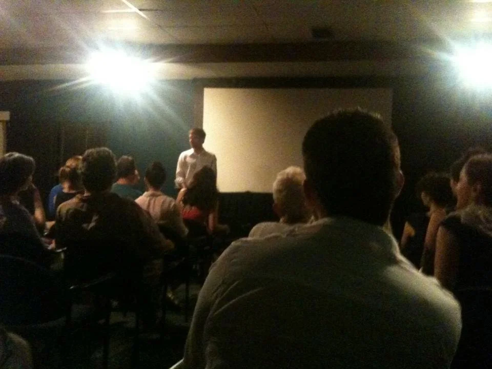 Man standing in front of screen at film screening