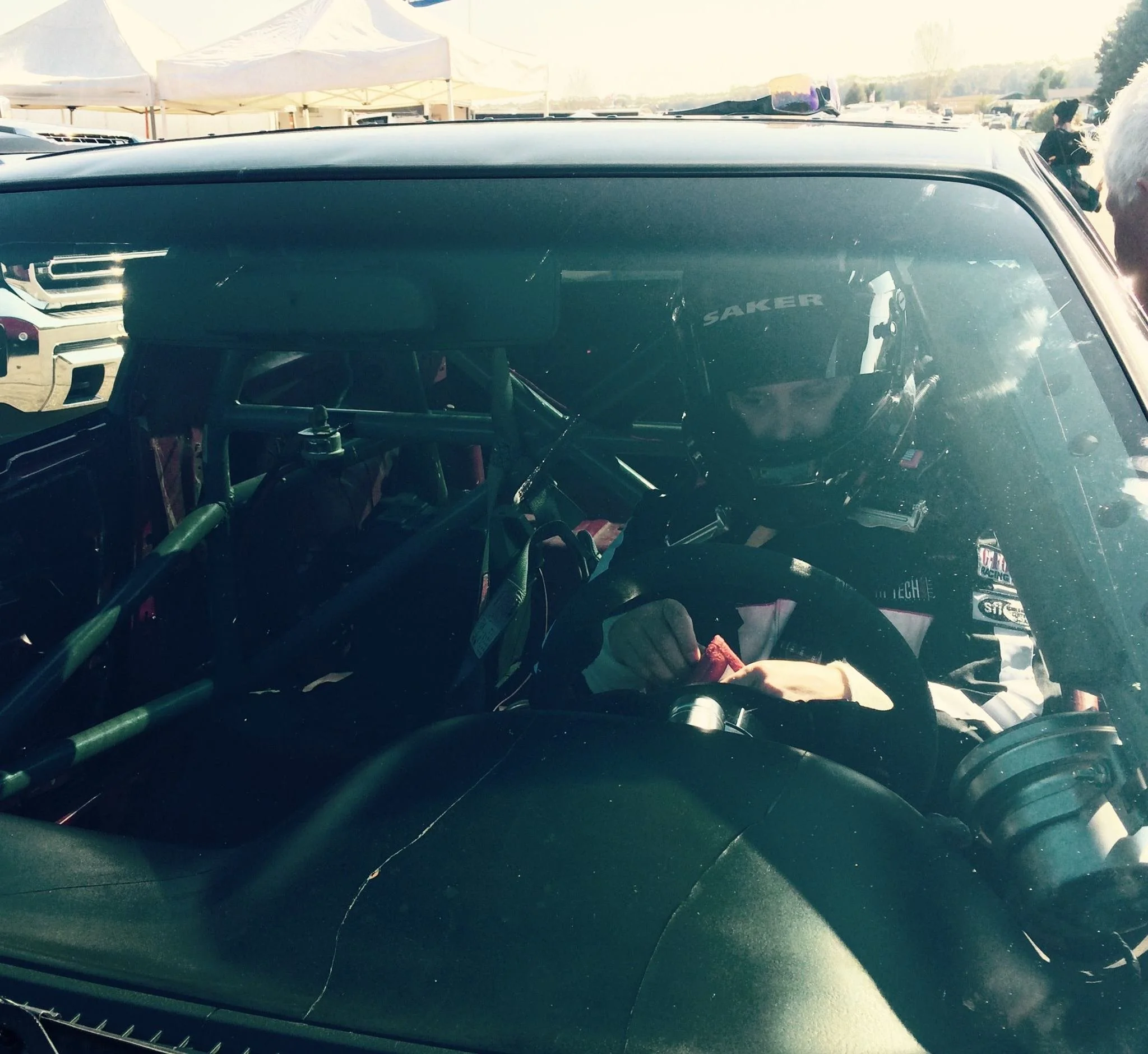 Man in race car. Photo taken in front of car.