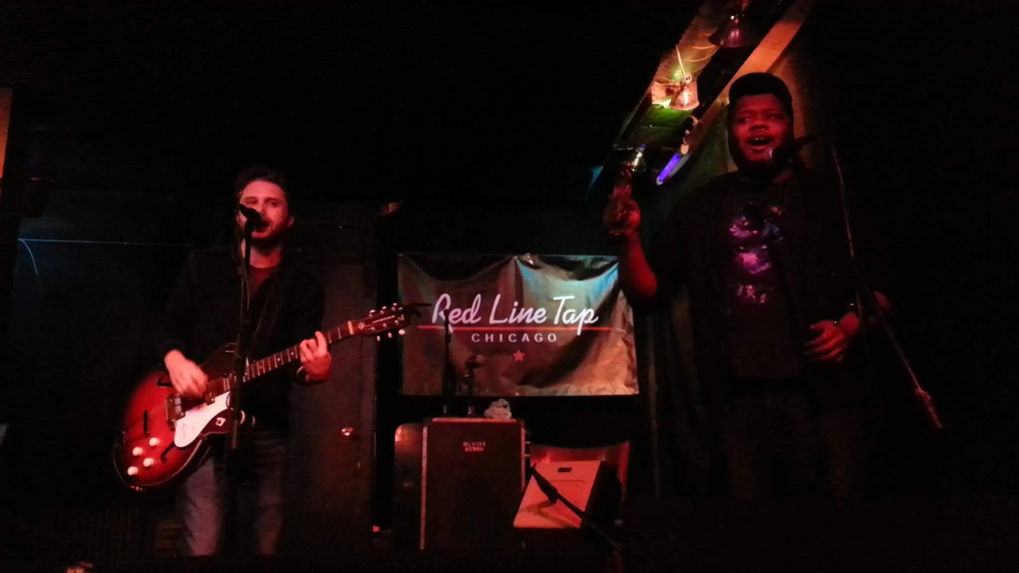 Two men performing music on stage