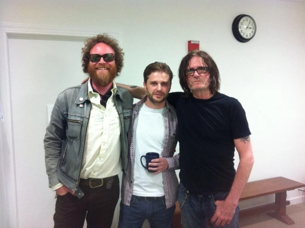 Three men standing, posing for photo
