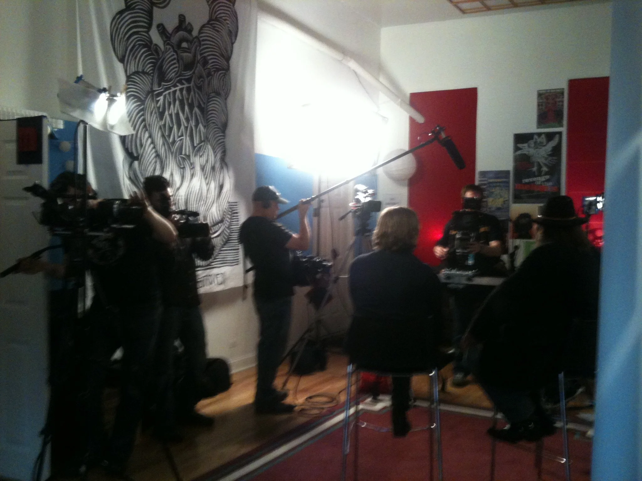 Film crew interviewing man