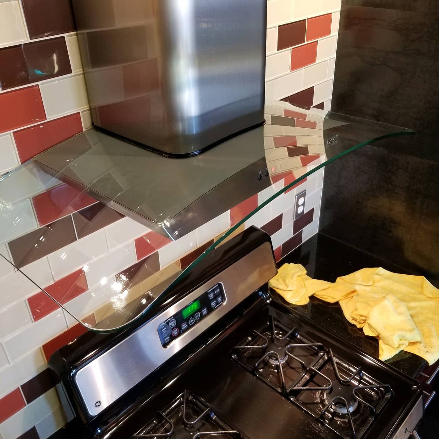 A stove range hood that has been cleaned of all grease and grime.