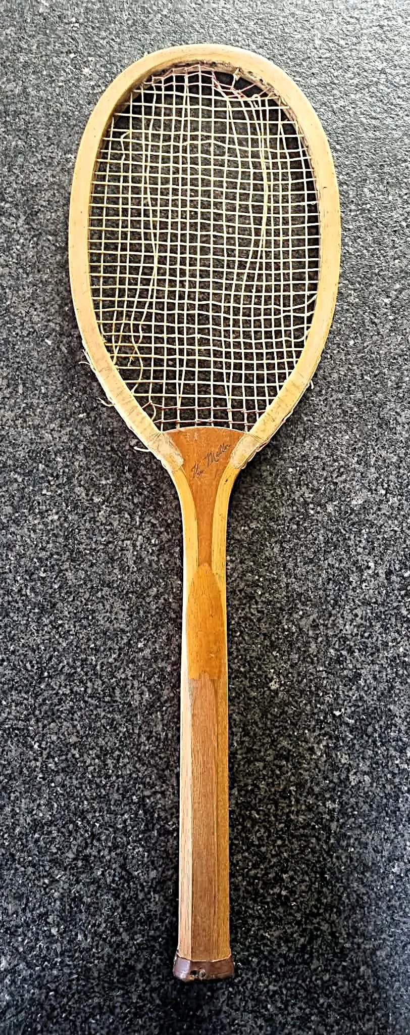 Antique Grays racket against a dark background