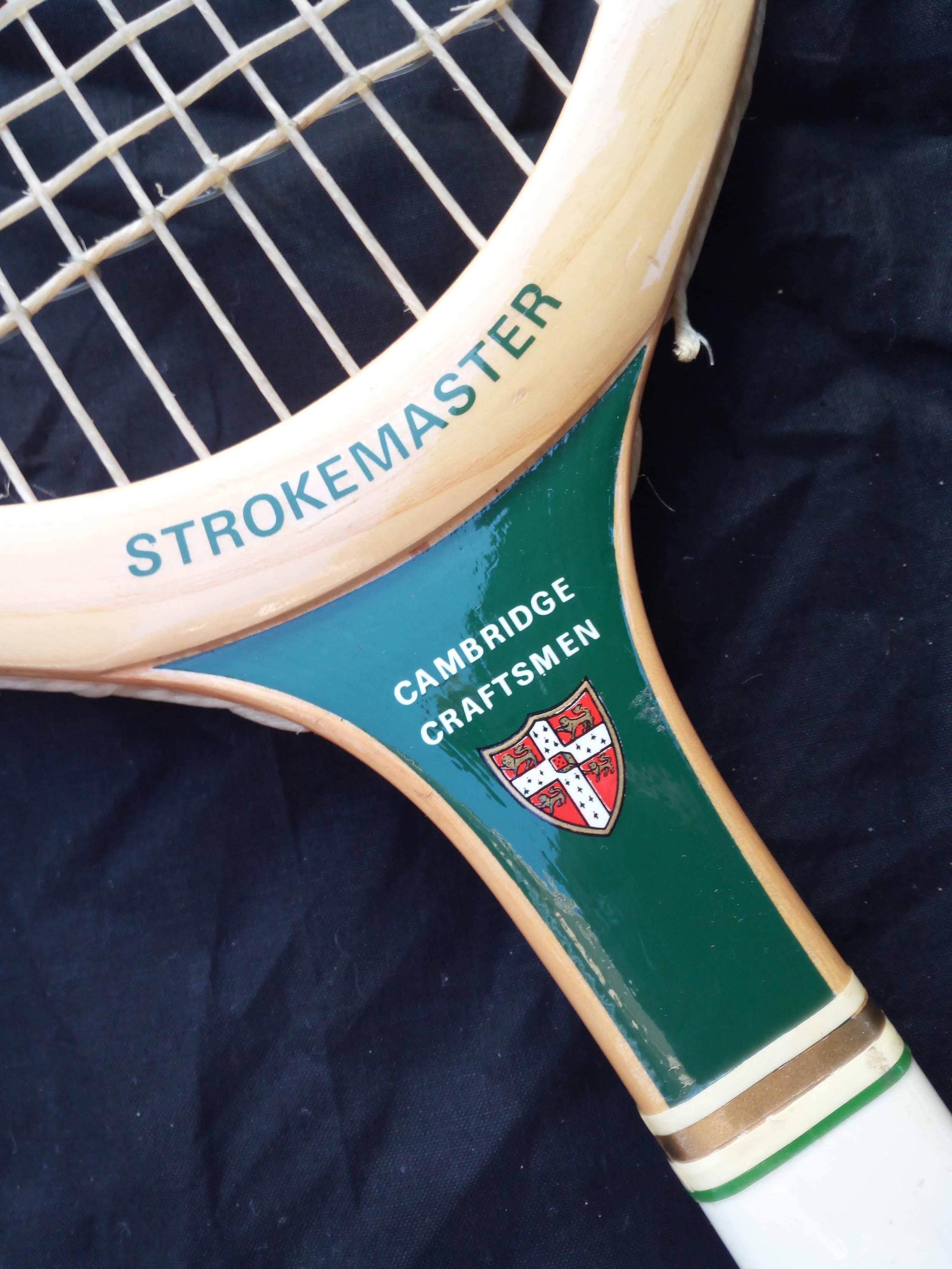 Throat of a heritage Grays racket against a black background.