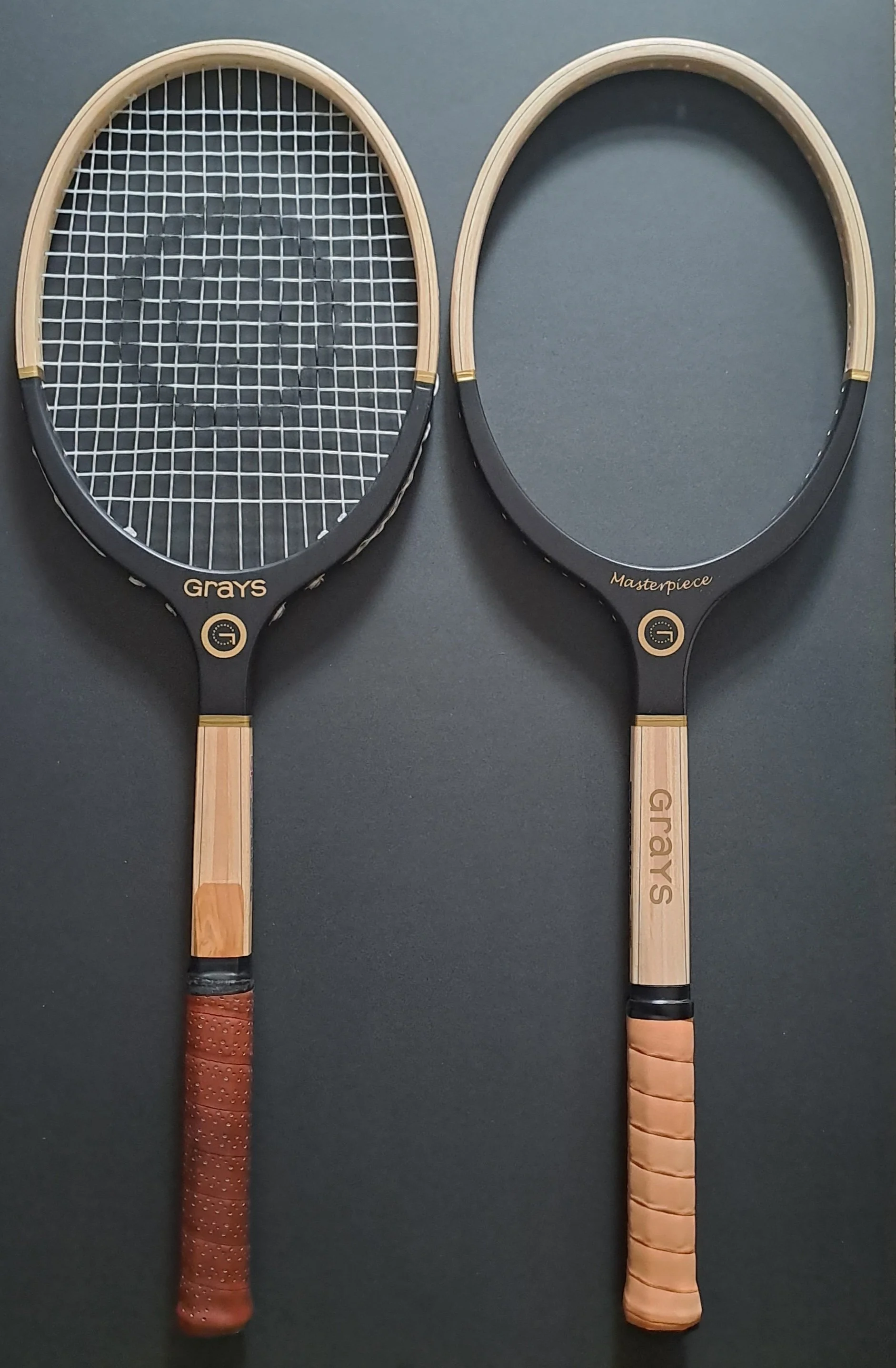 Two Grays rackets side by side against black background