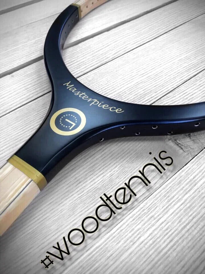 Throat section of Grays racket resting on wood with "#woodtennis" text