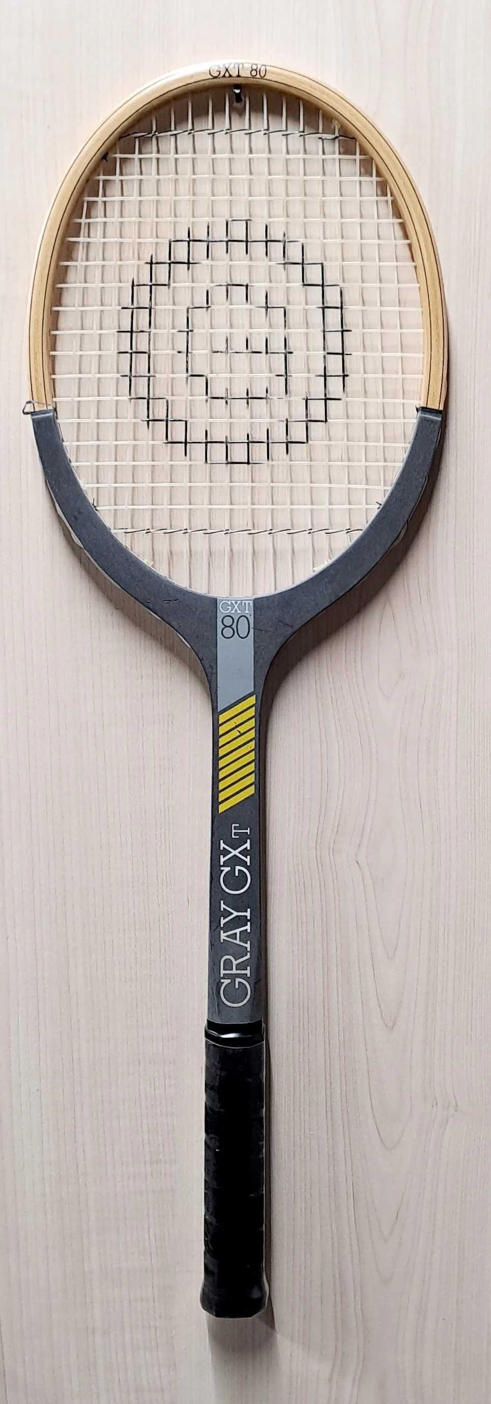 Full length of heritage Grays racket against pale background.