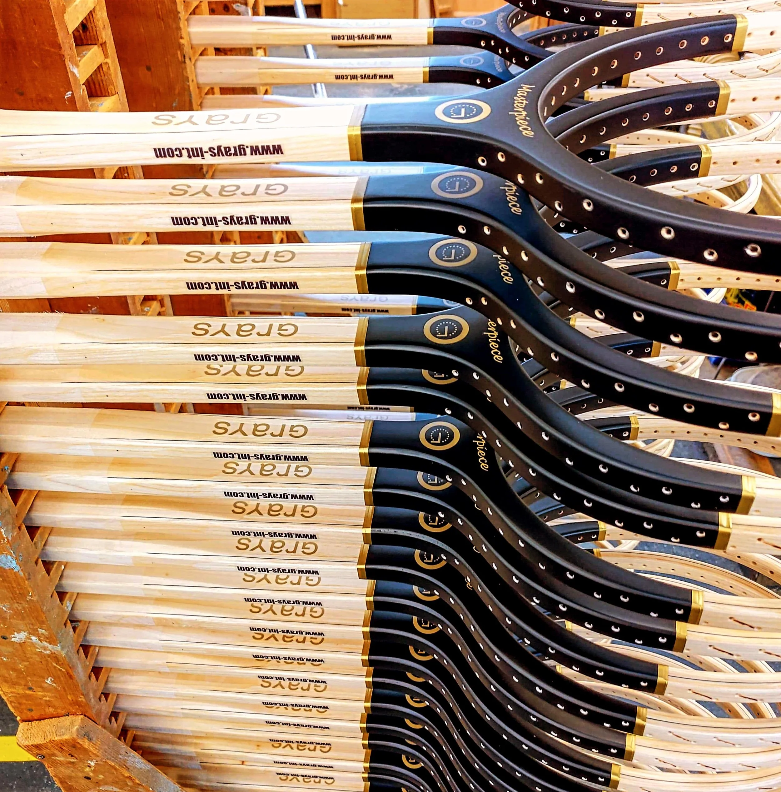 Stacks of Grays wooden tennis frames during the manufacturing process.