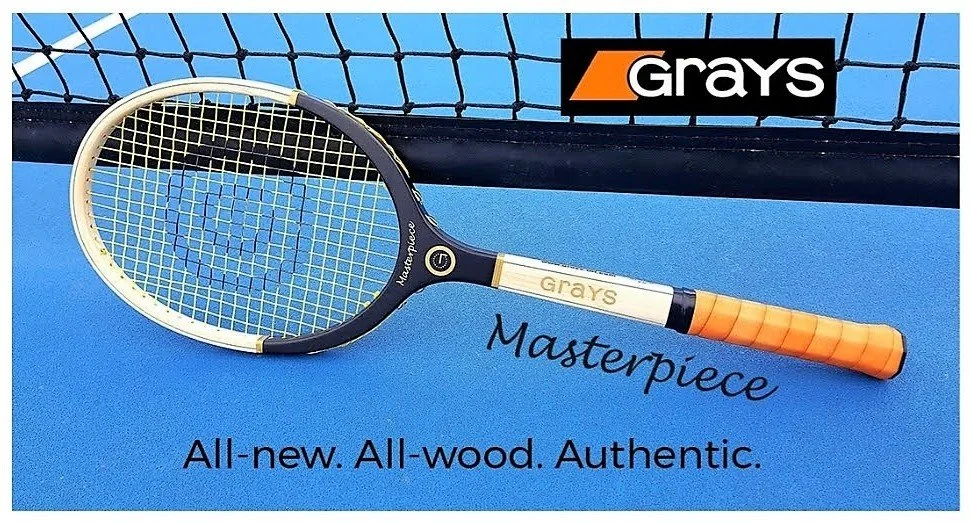 Grays wood racket on a blue court against a net