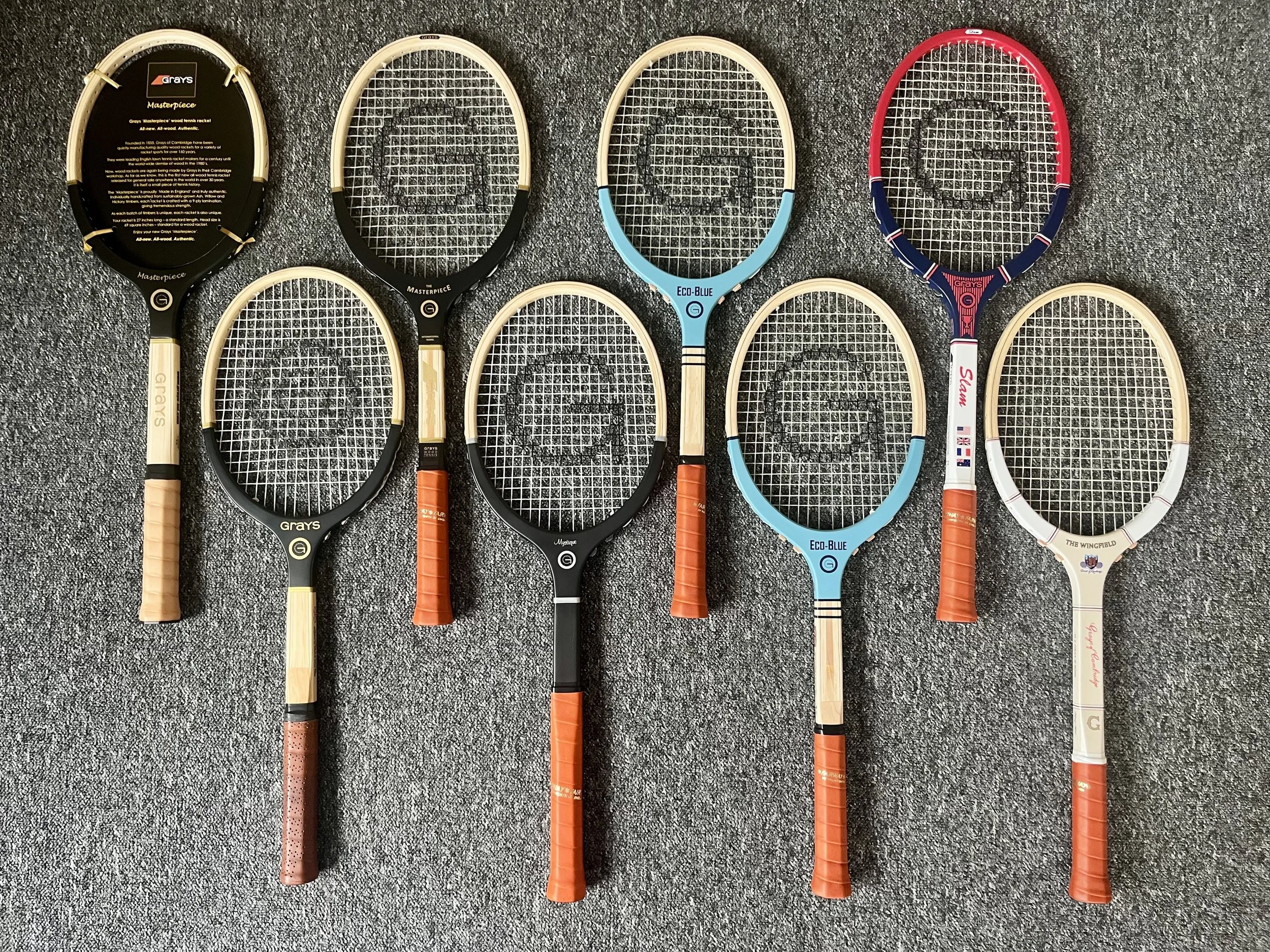 Eight Grays wood rackets against a grey-brown background