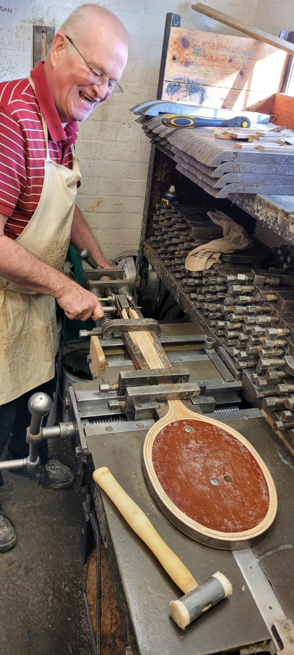 Tim Dowe assembling a new wooden tennis racket in the Grays factory