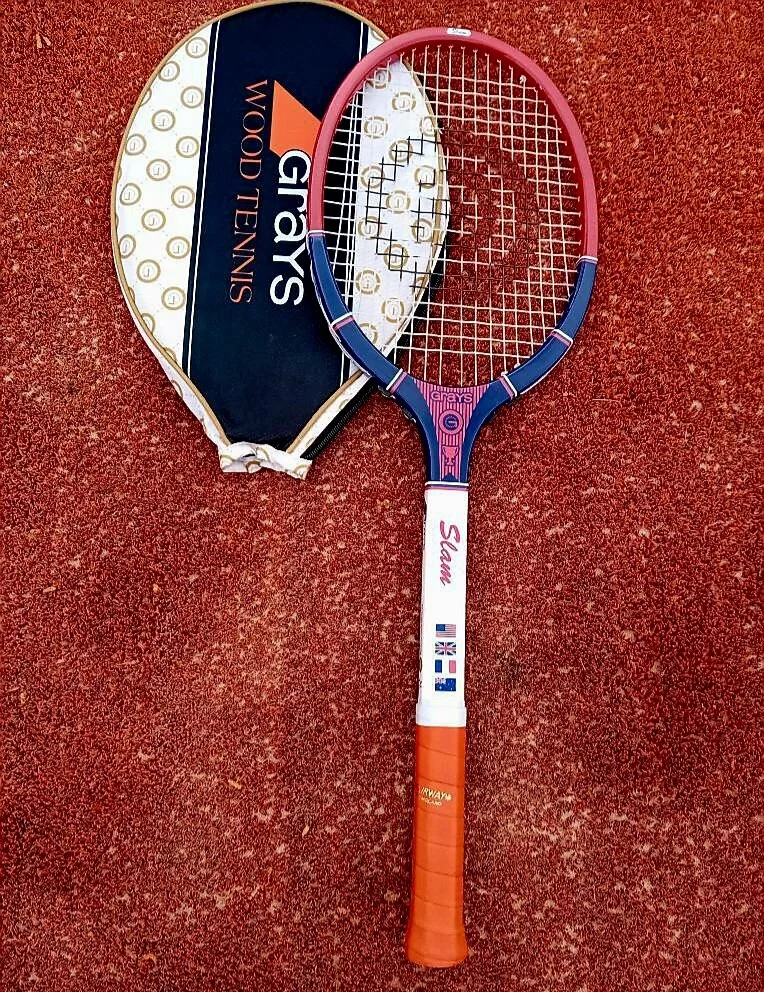 Slam wooden tennis racket with a Grays Wood Tennis cover on a clay court.