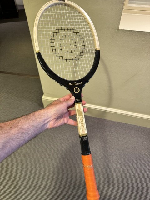Grays wood racket indoors being held by a hand