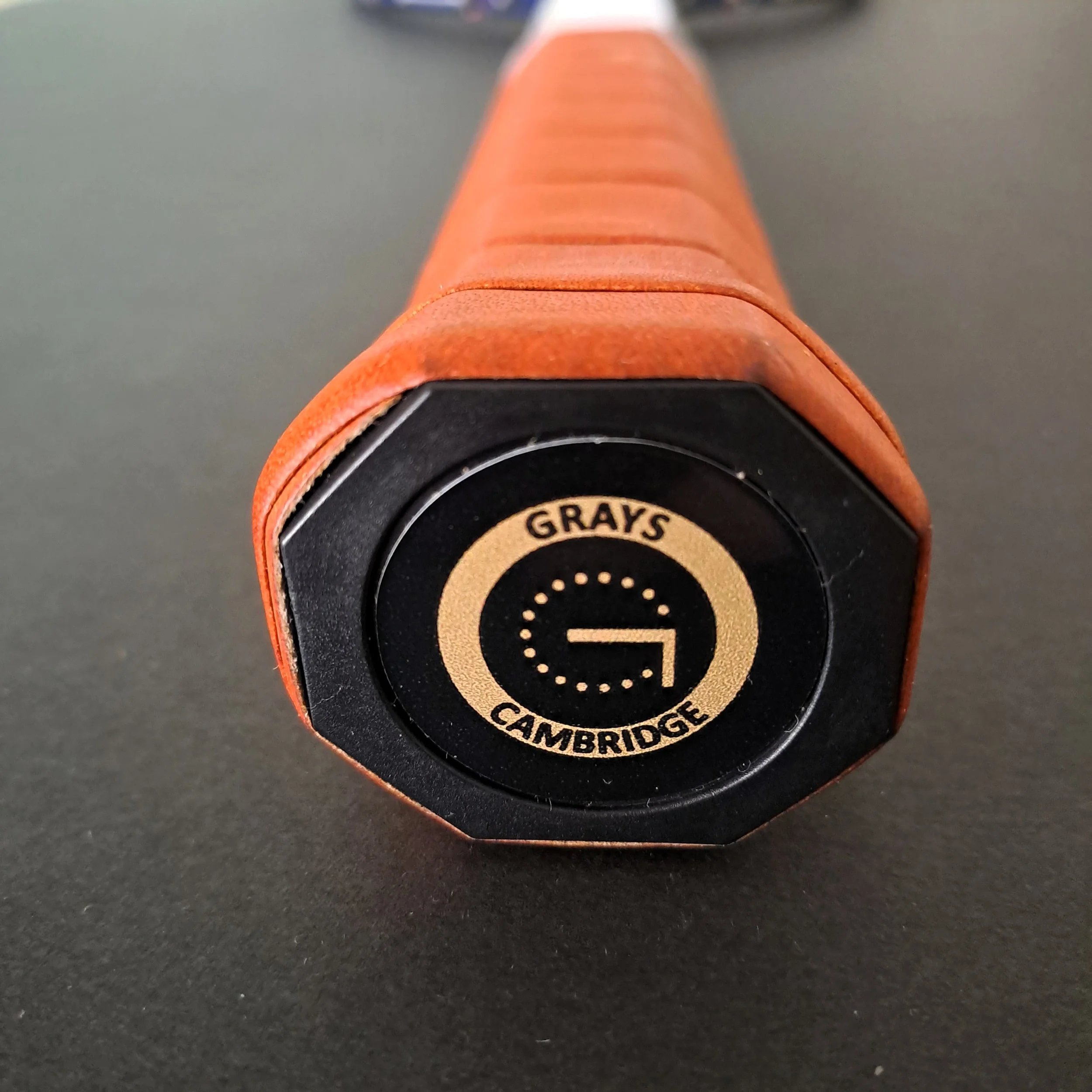 Close-up of Grays Slam grip showing end cap with Grays label.