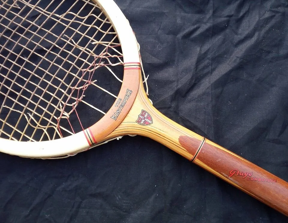 Vintage Grays racket on a black background.