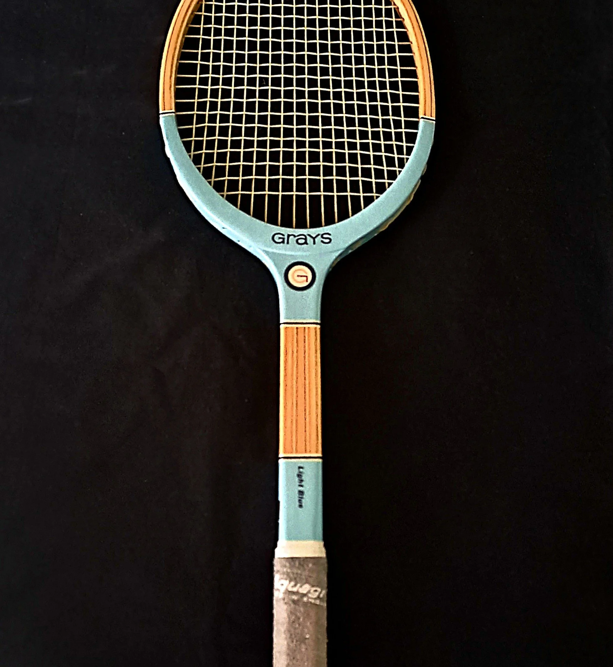 Grays Light Blue racket against a black background.