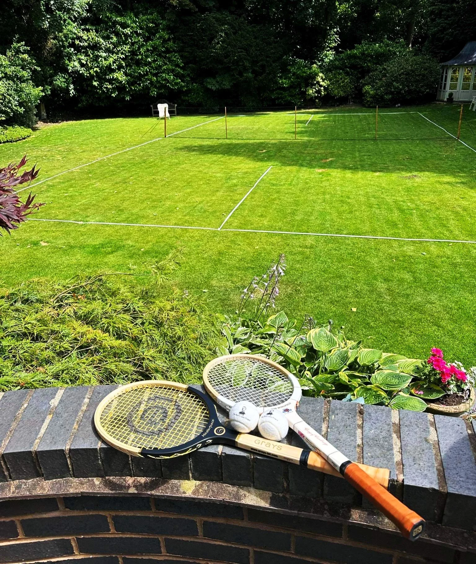 Grays Masterpiece and The Wingfield on wall with grass court in background.