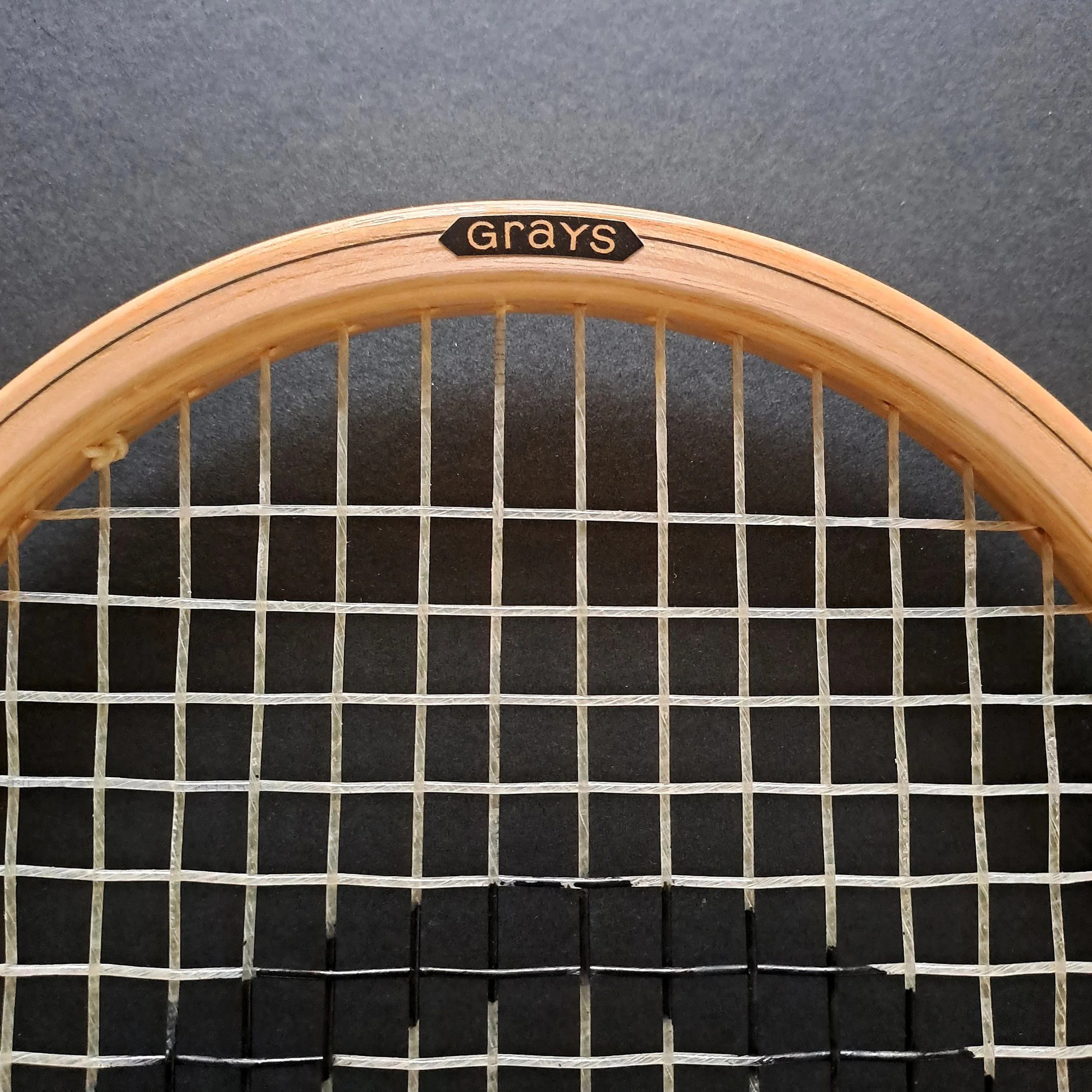 Close-up of Grays The Masterpiece top of frame showing strings and Grays cosmetic.