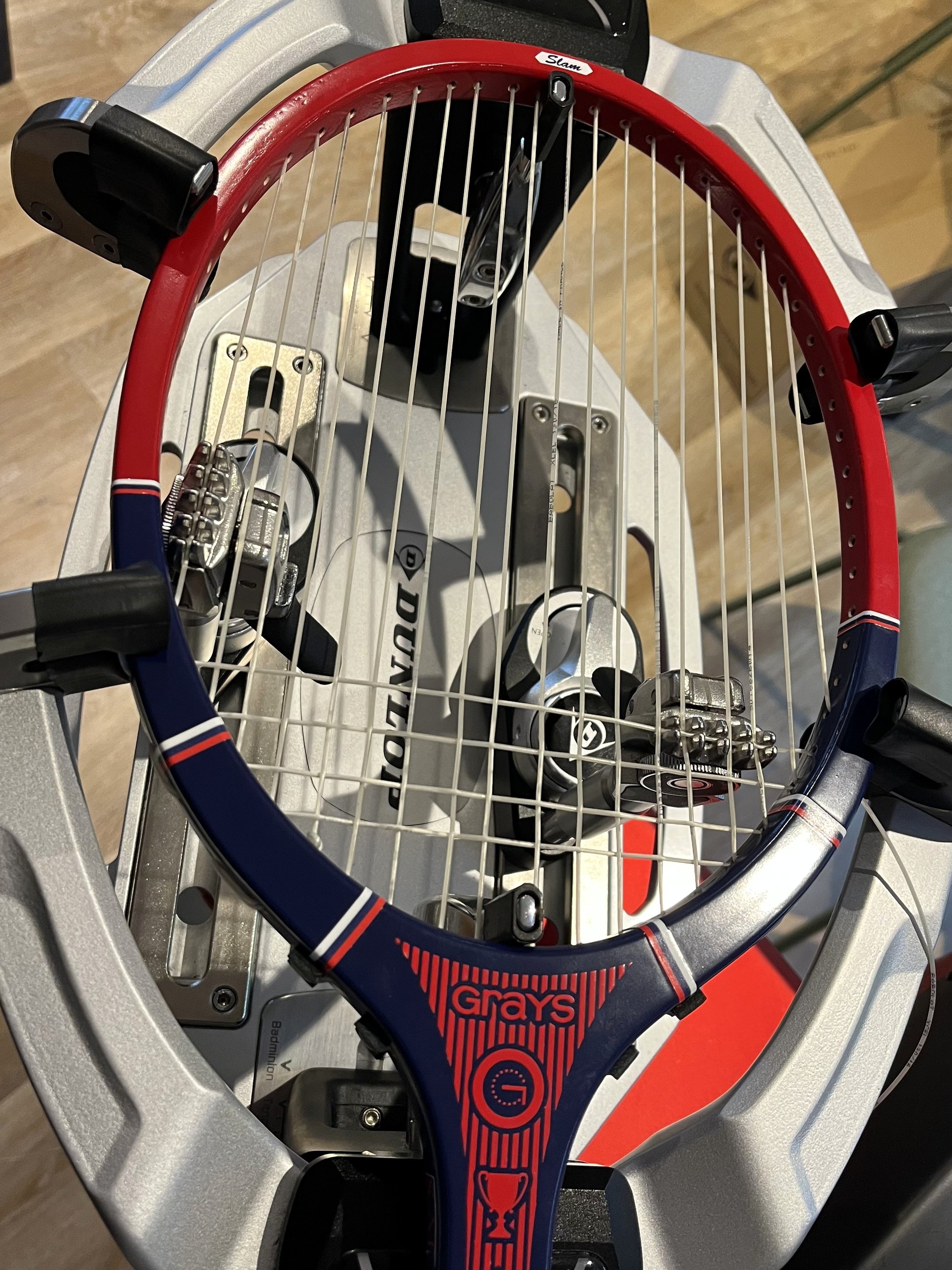 Grays Slam racket mounted on stringing machine