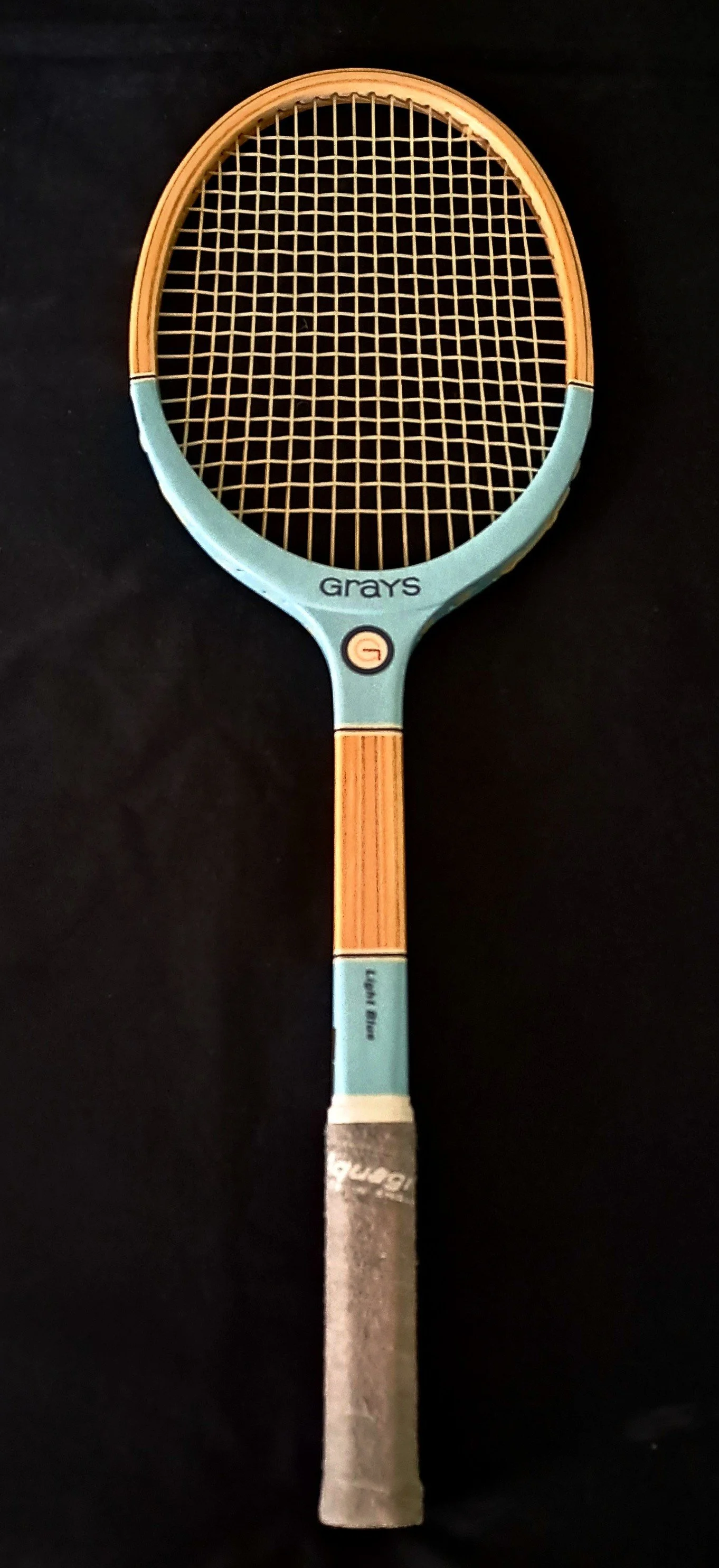 Grays Light Blue racket against a black background