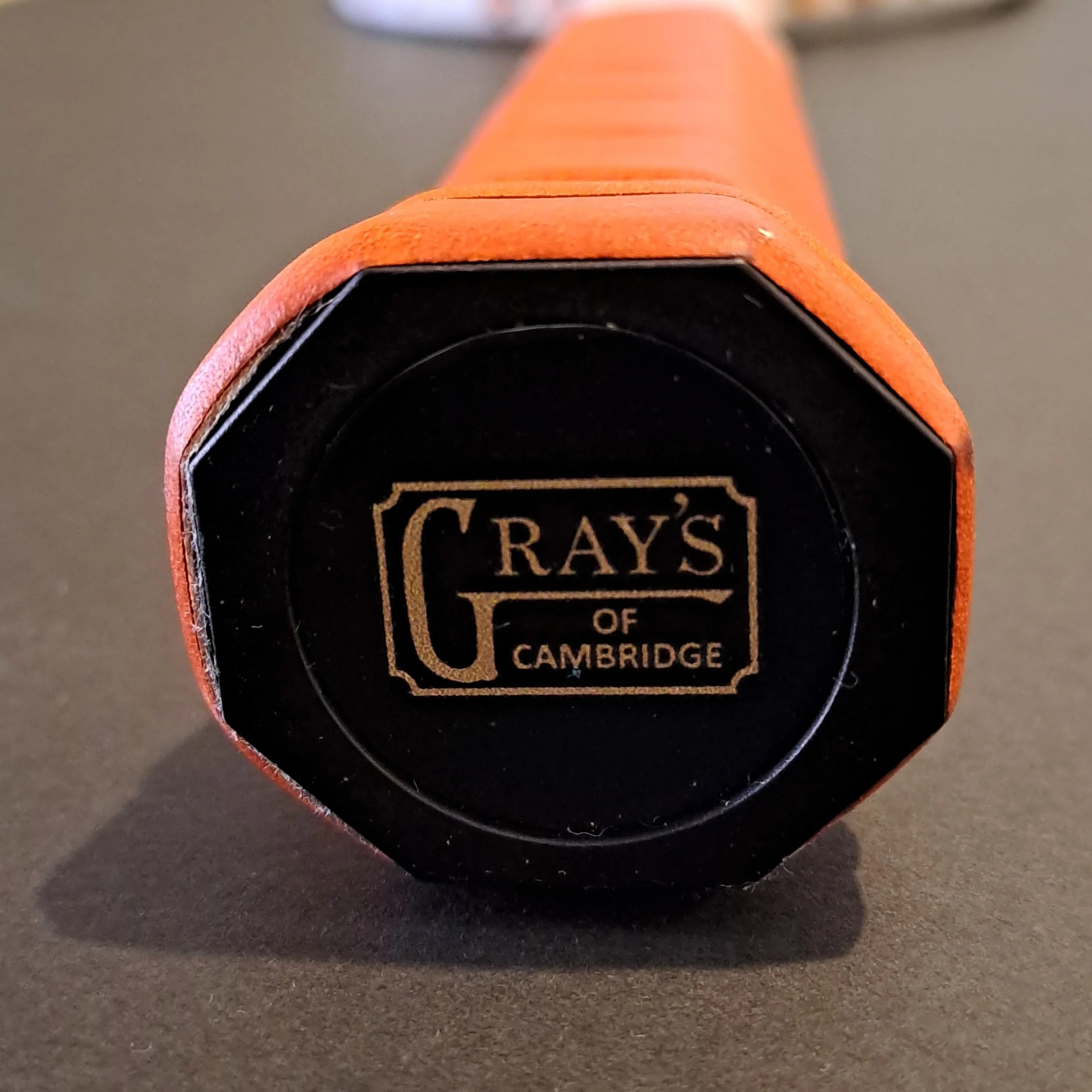 Close-up of Grays The Wingfield end cap and grip showing end cap label.