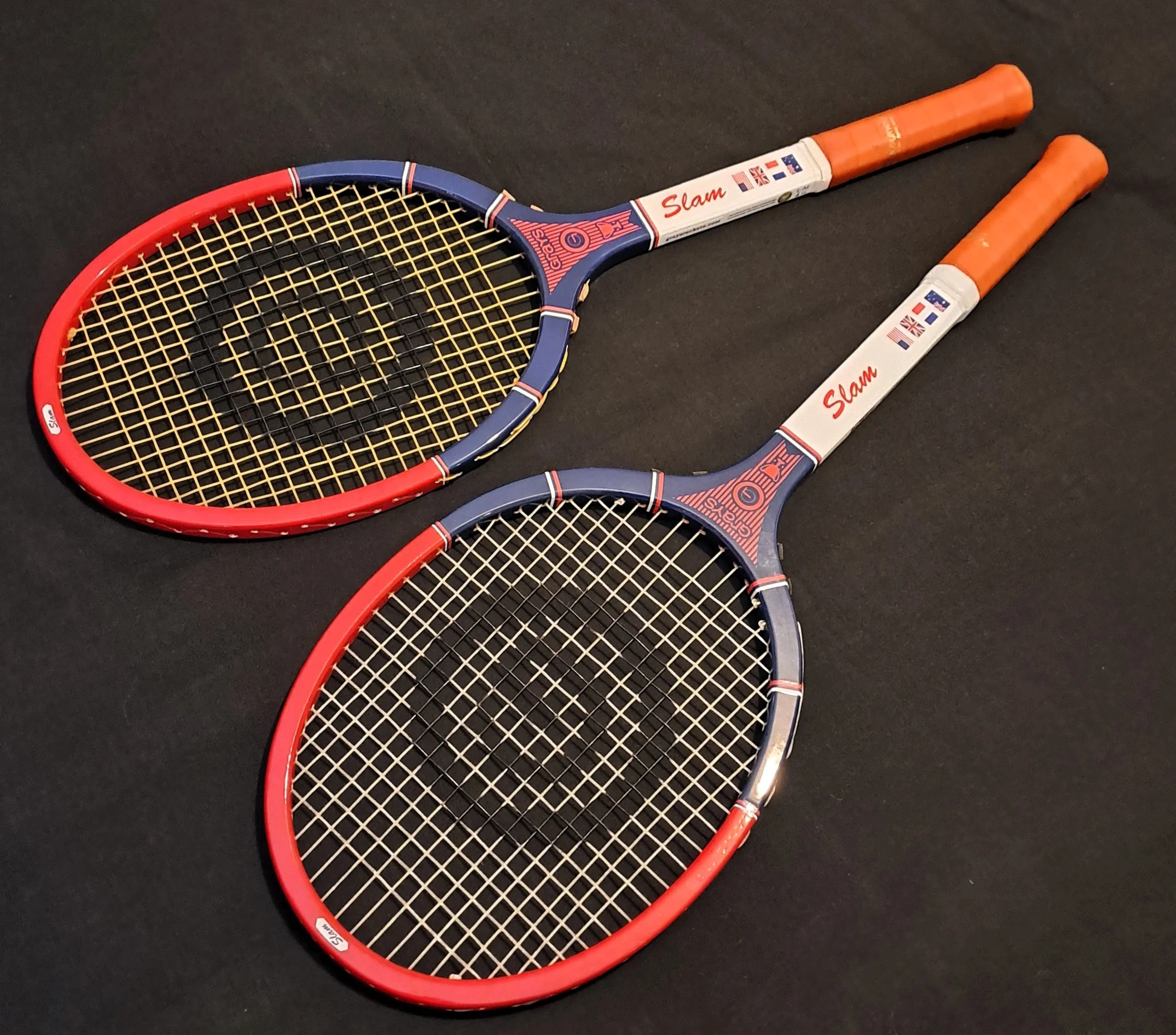 Two Grays Slam rackets against a black background.