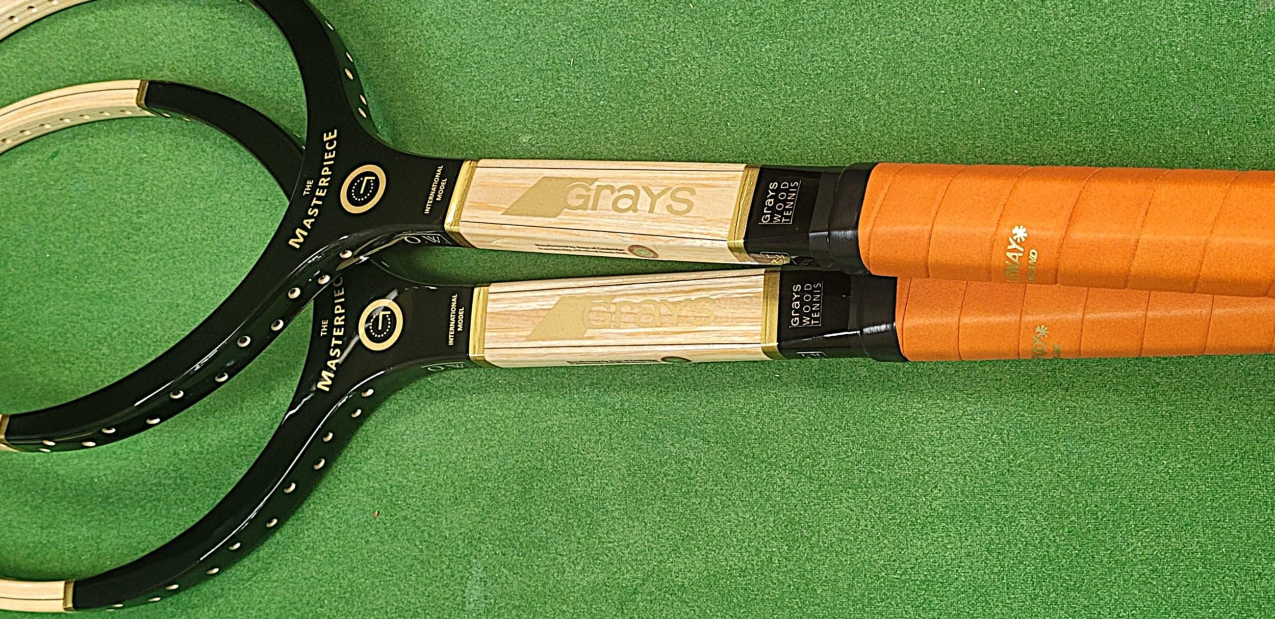 Two Masterpiece frames resting on a green surface.