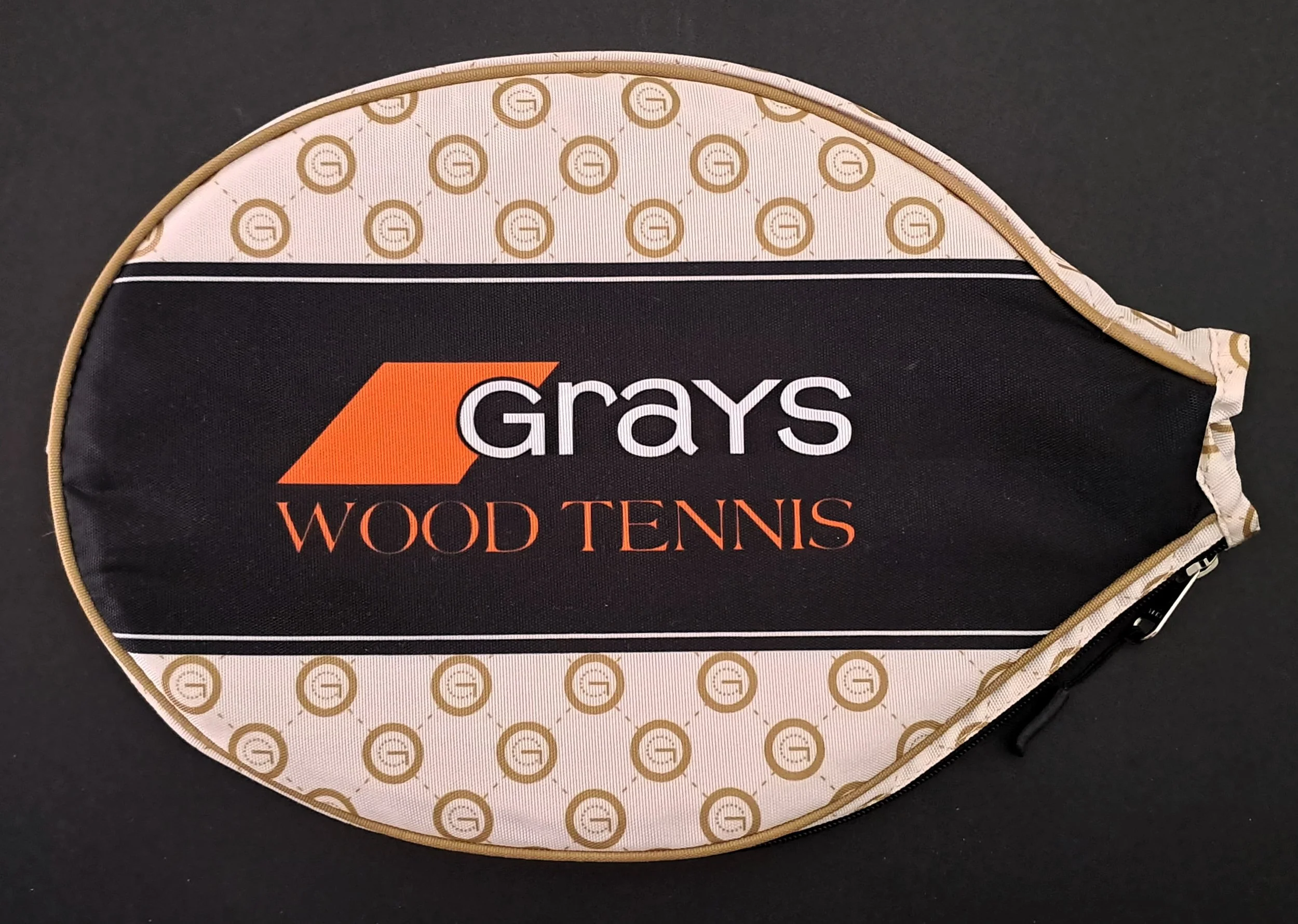 A Grays Wood Tennis racket cover against a black background..
