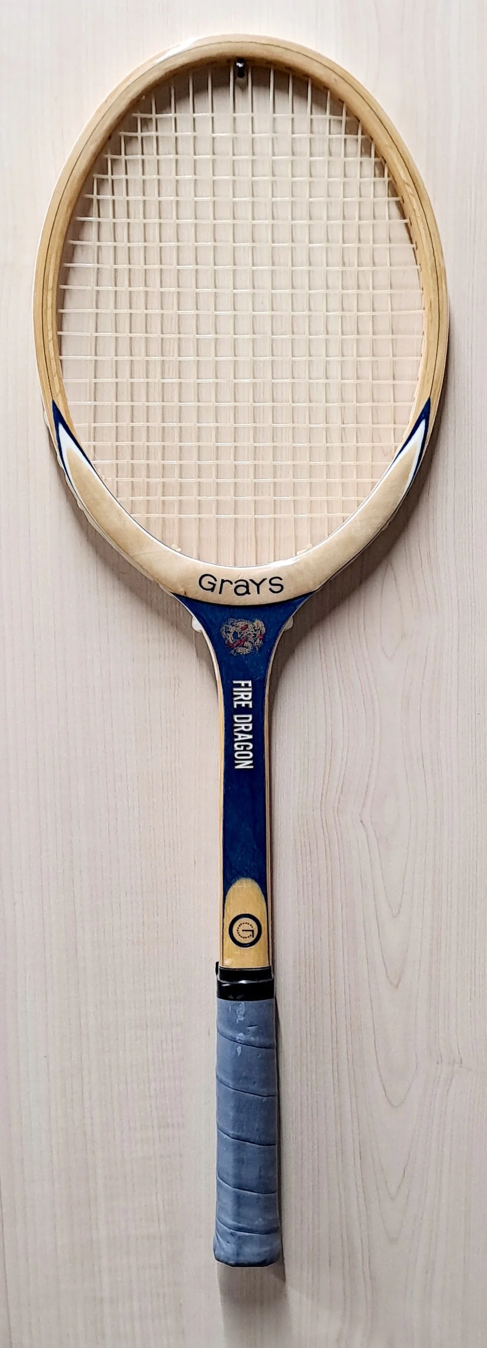 Full length of heritage Grays racket against pale background.