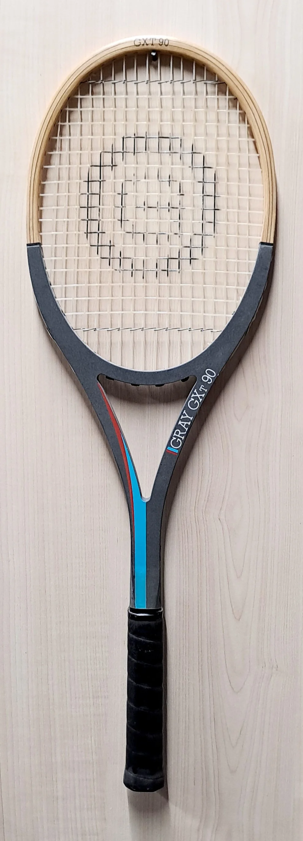 Full length of heritage Grays racket against pale background.