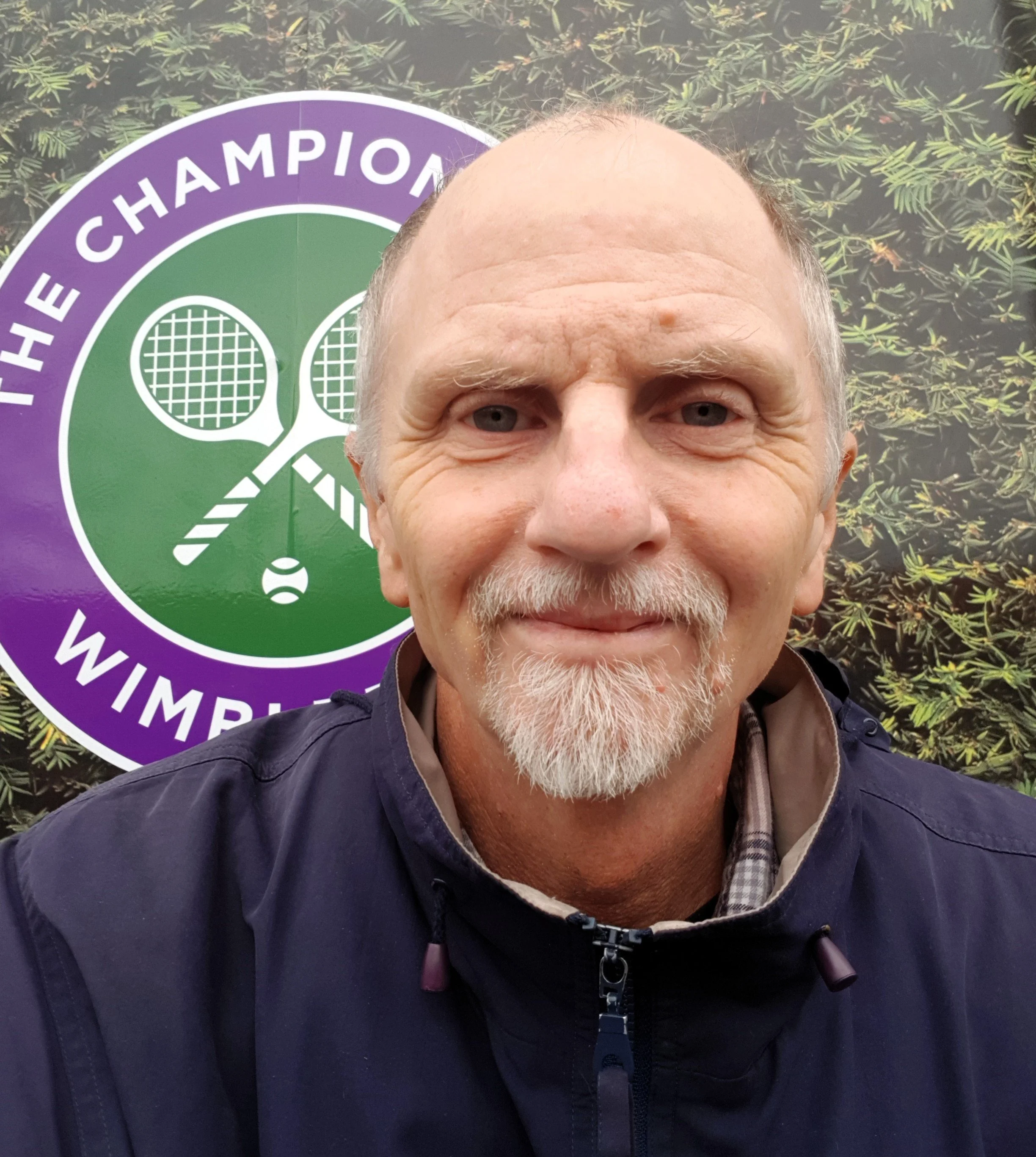 Head and shoulders photo of Stephen Murphy with Wimbledon logo in background