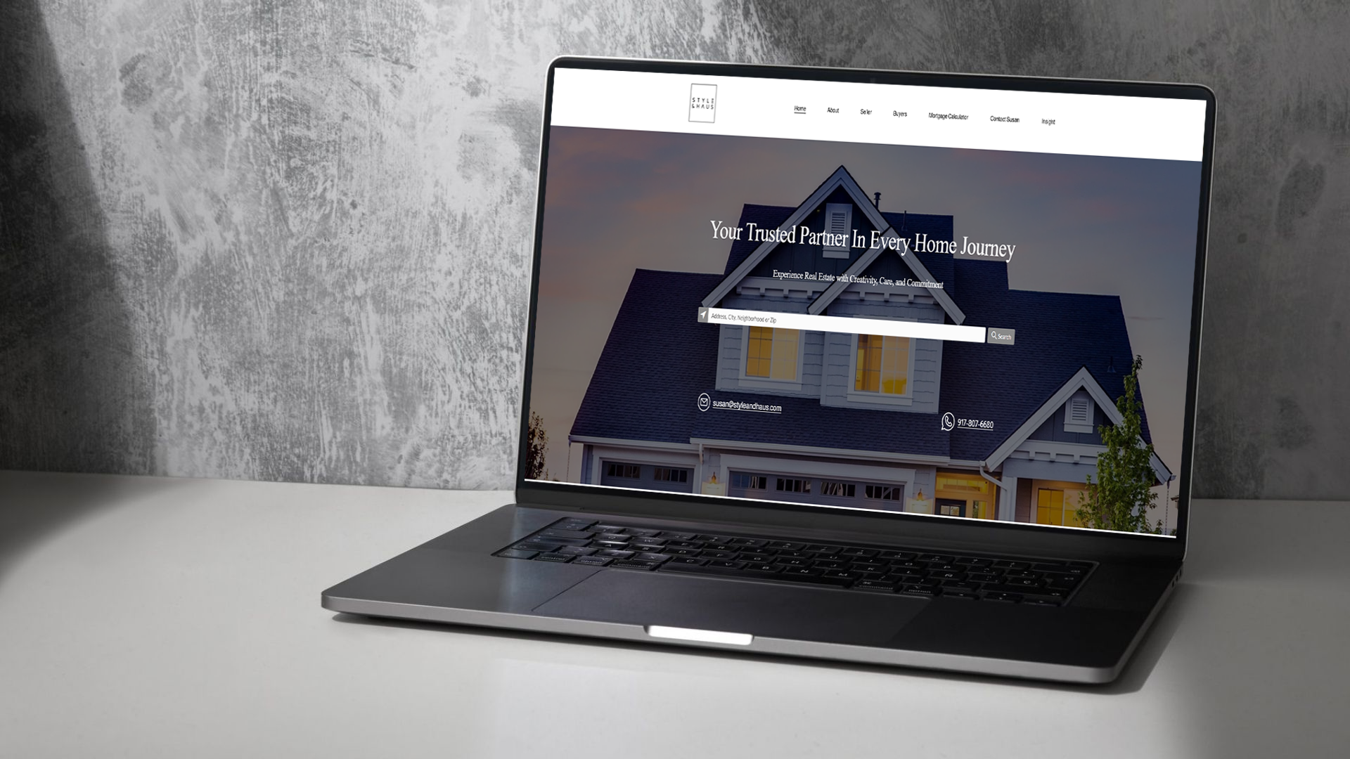 Laptop displaying a real estate website homepage with a home search feature and headline reading ‘Your Trusted Partner in Every Home Journey.’