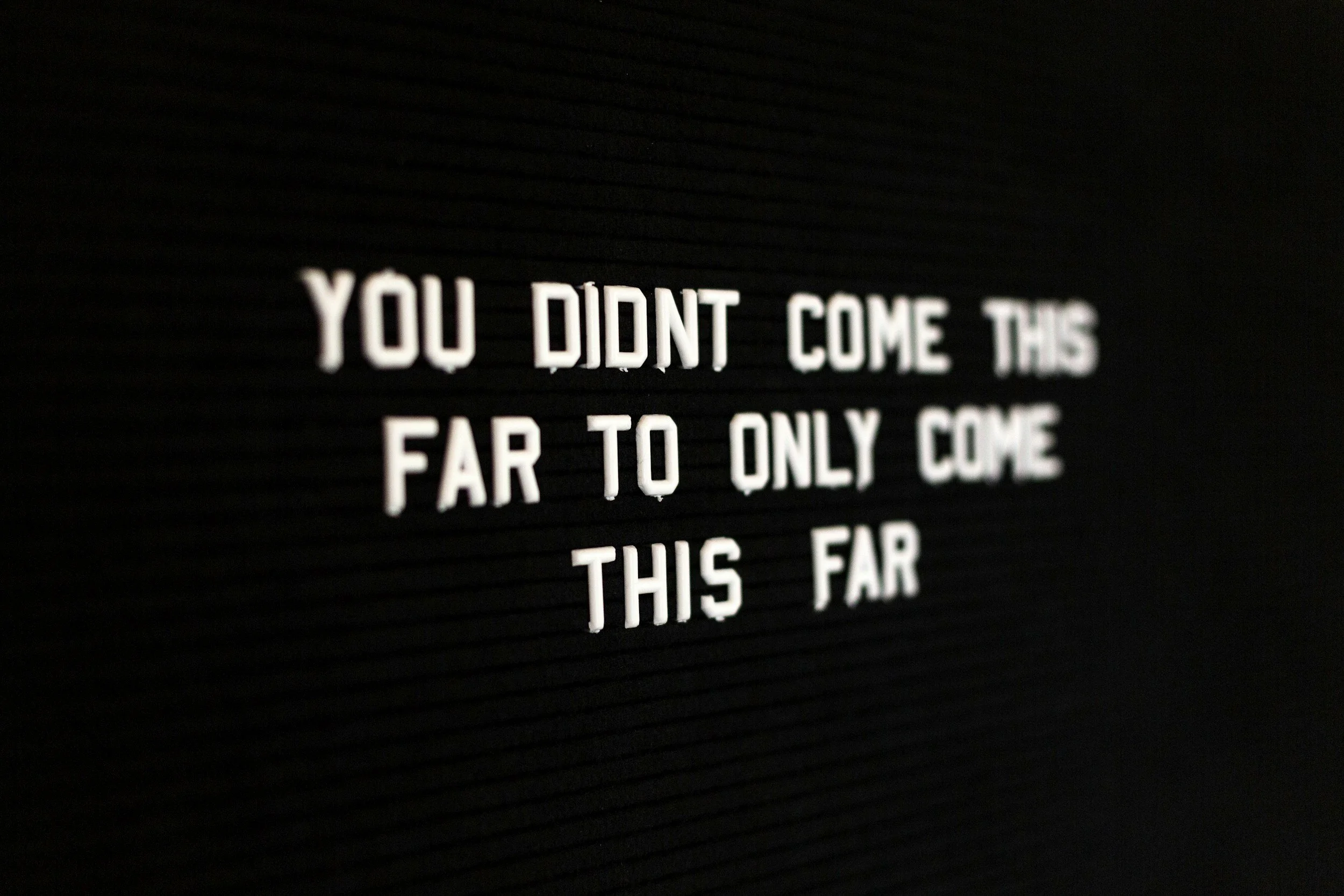 Letter board with the text 'You didn't come this far to only come this far' in white letters on a black background.