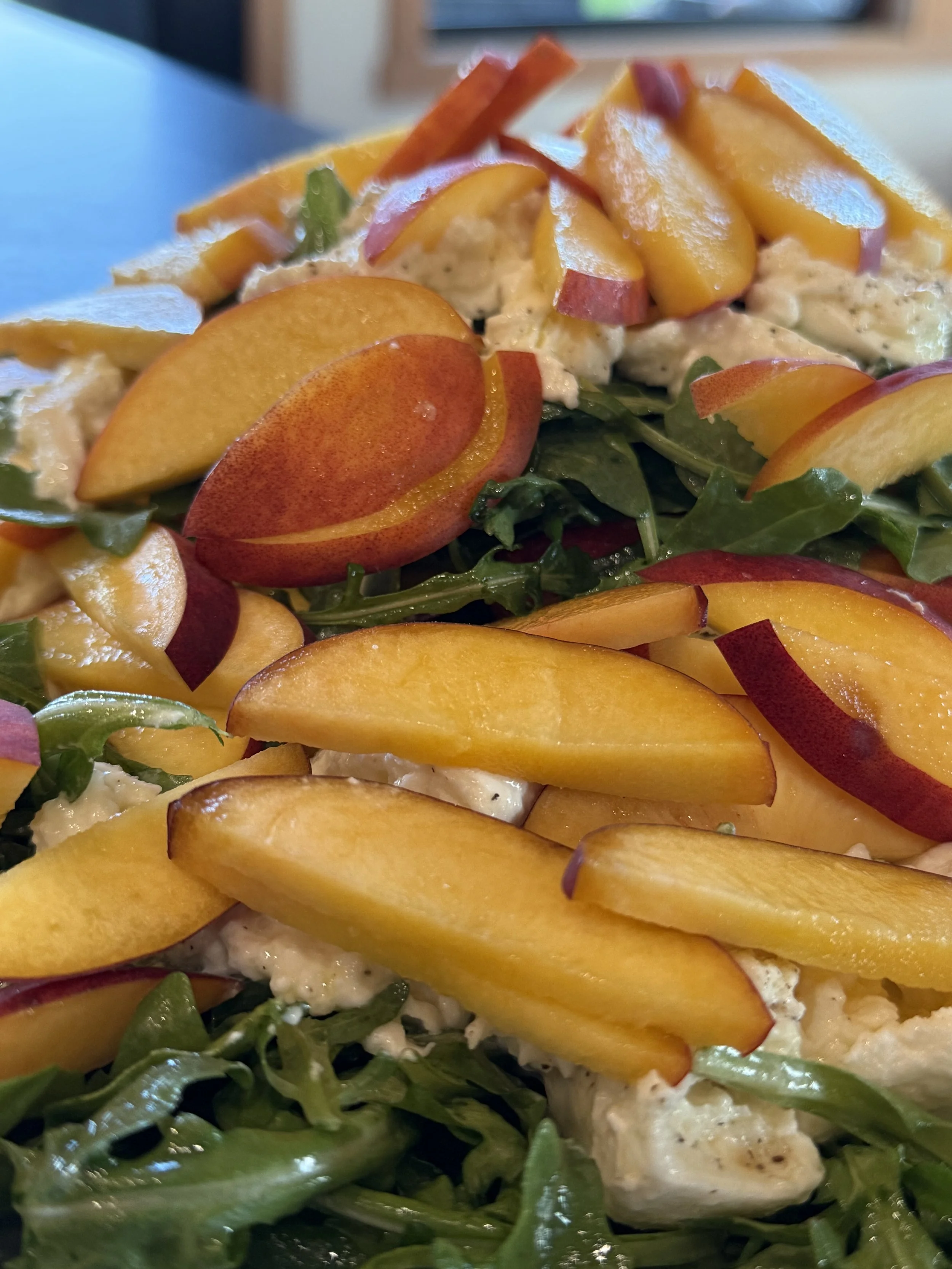 Fresh local peaches, burrata cheese, home grown arugula